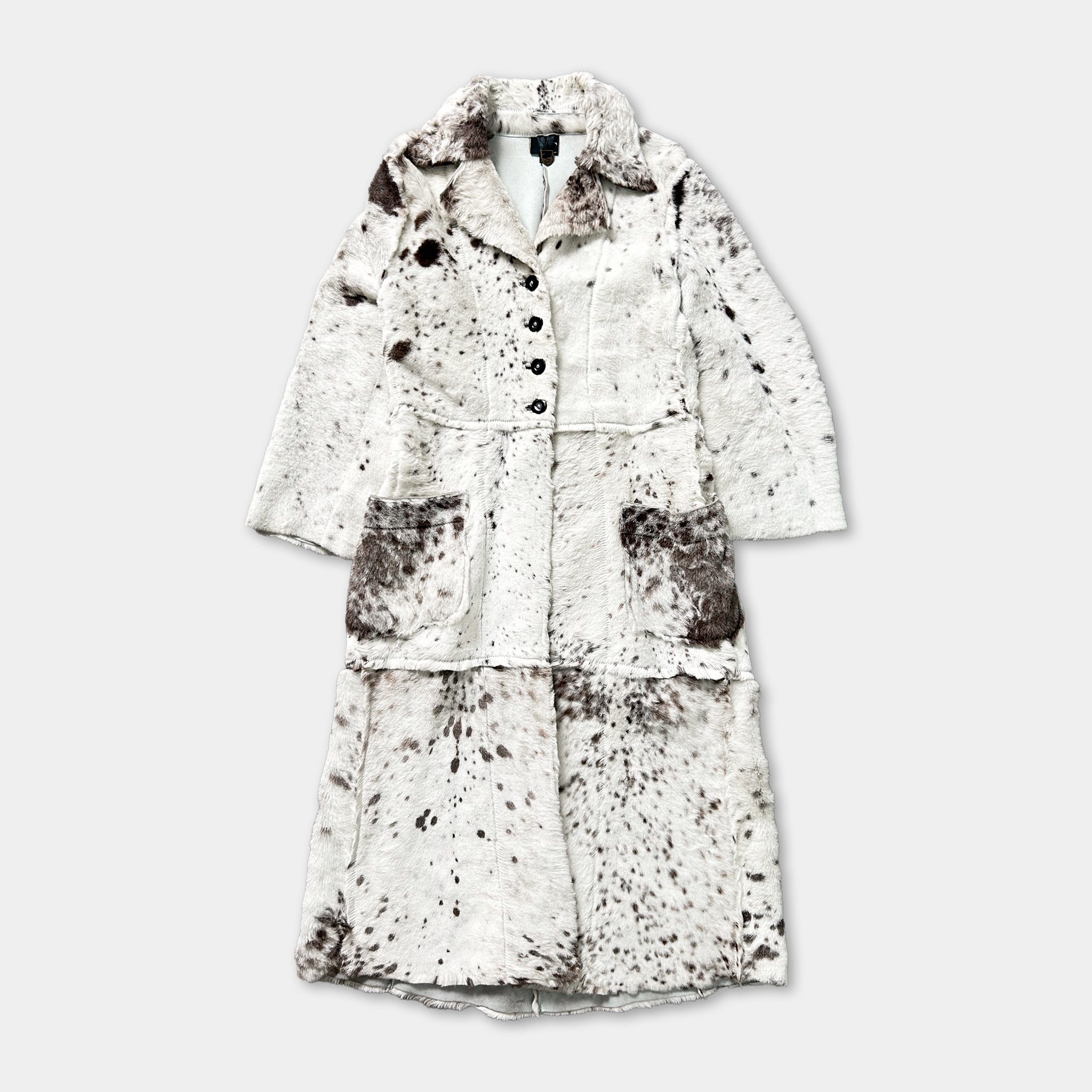 A long, white fur coat with a distinctive spotted pattern.