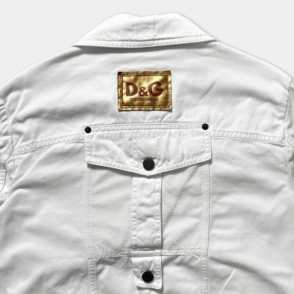 a close-up view of the back of a white jacket with a D&G logo patch on the left side.