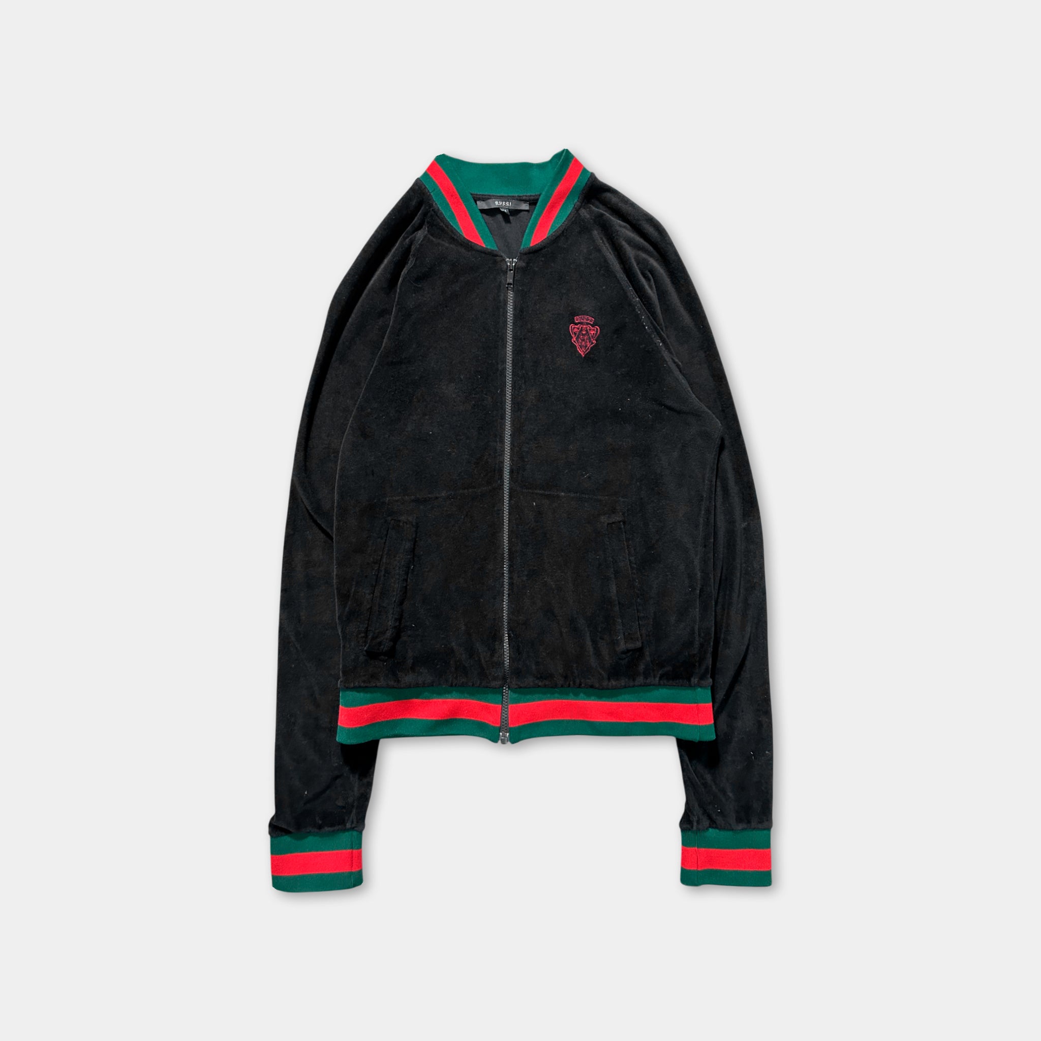 A black zip-up jacket with red and green stripes on the sleeves and collar.