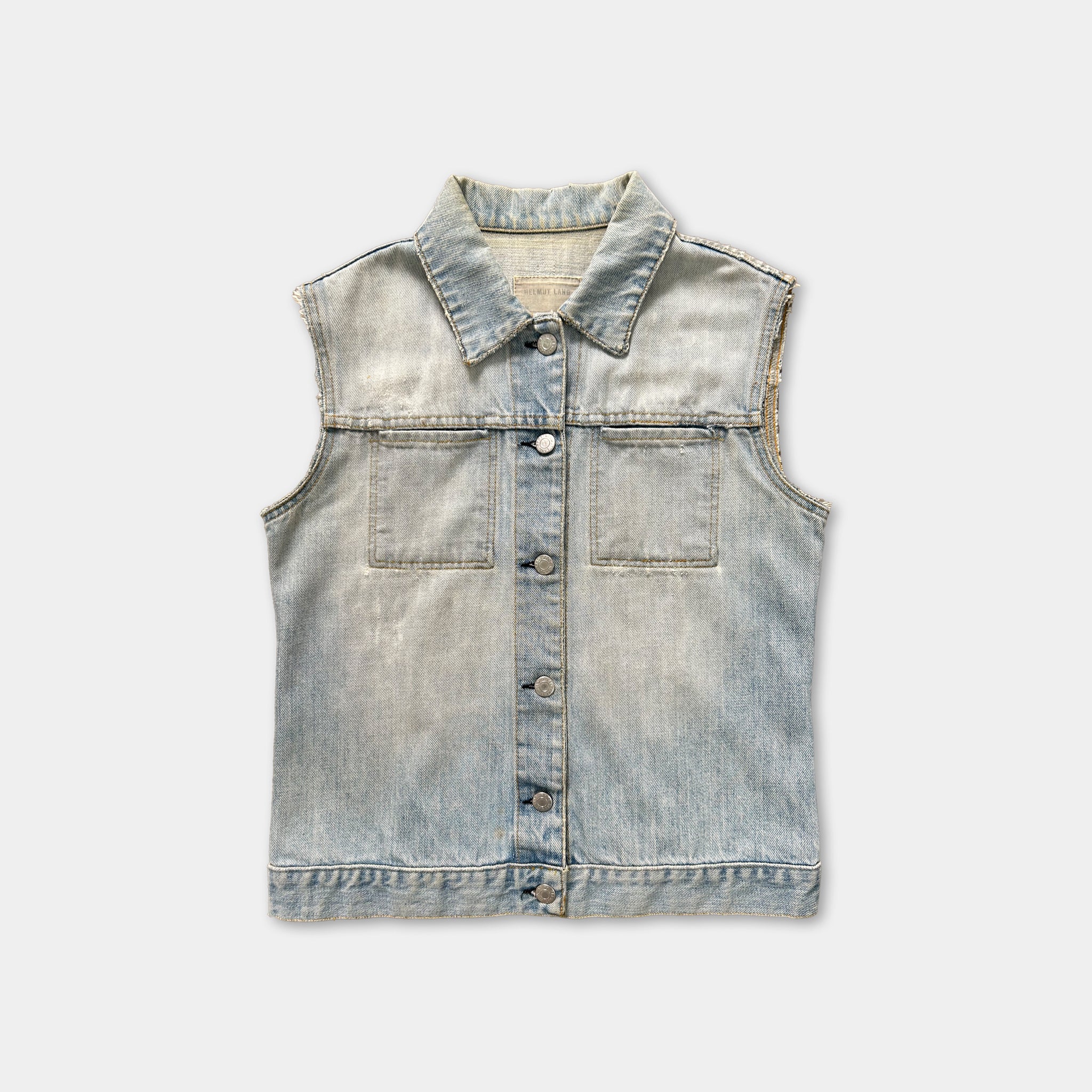 A denim sleeveless shirt with a button-down front and two pockets.