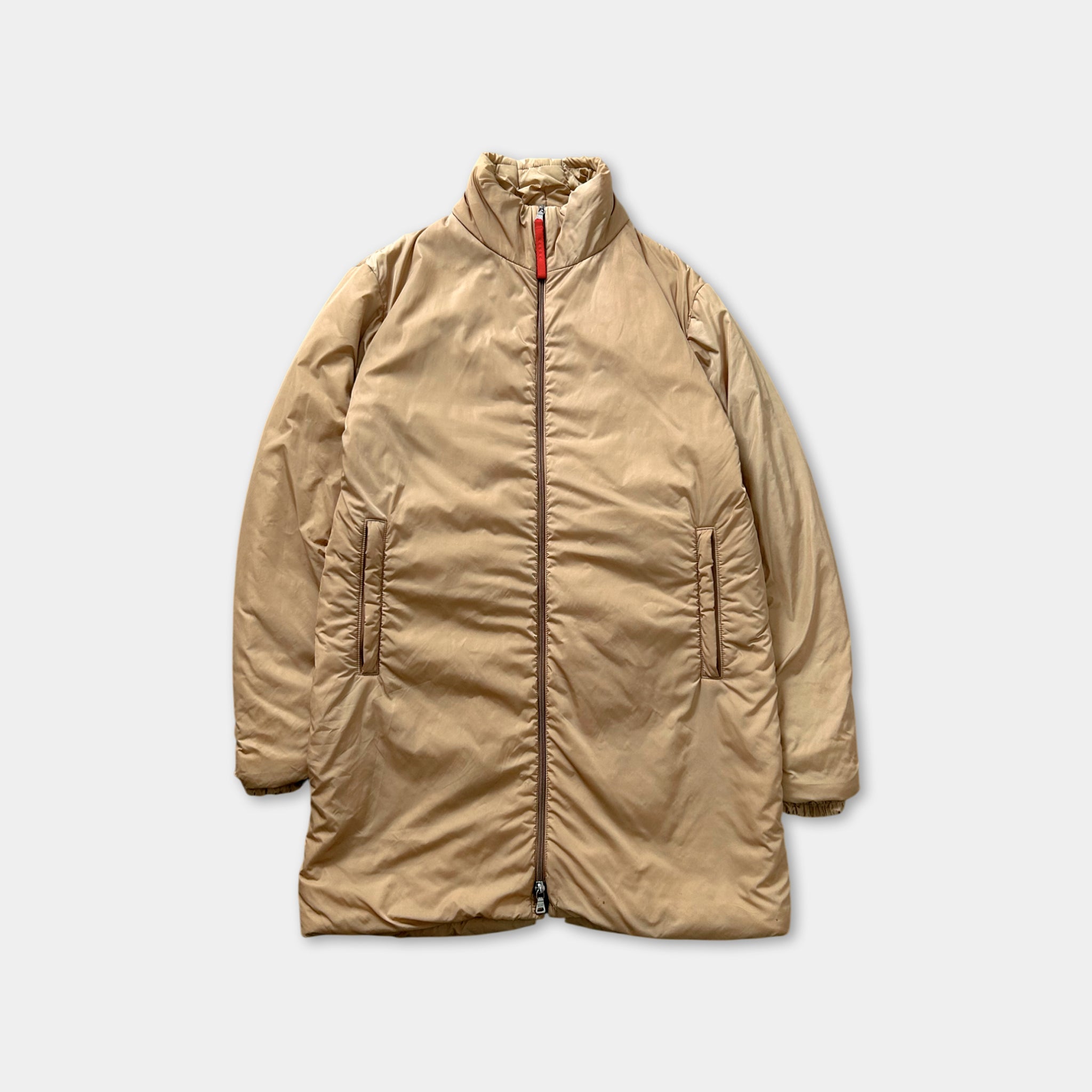 A tan-colored jacket with a zipper and two pockets, displayed against a plain background.