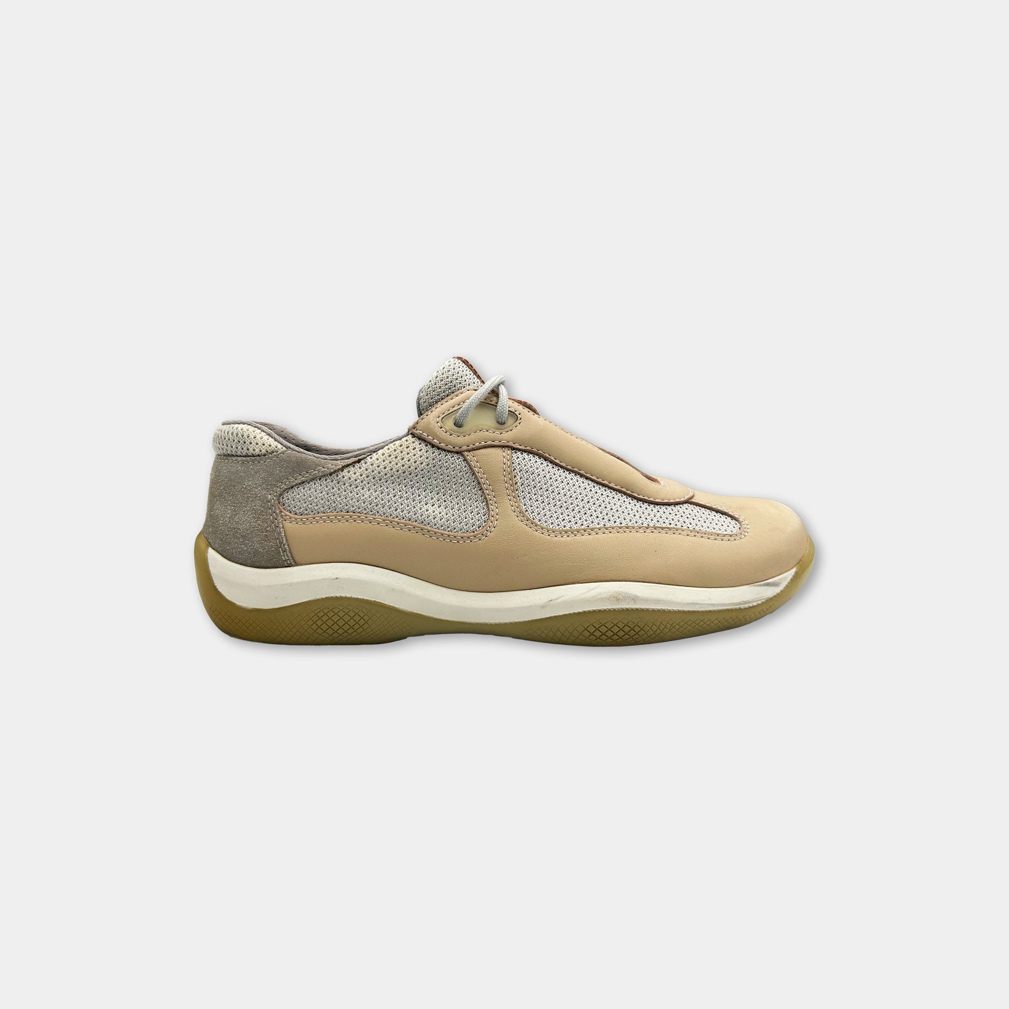 A single beige and gray athletic shoe against a white background.