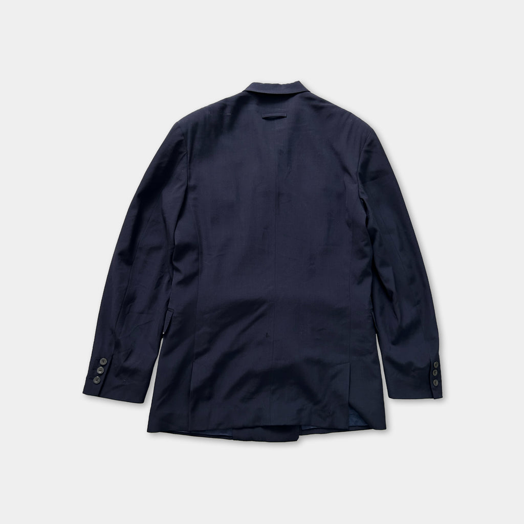 A navy blue blazer with long sleeves and buttons, laid out flat against a white background.