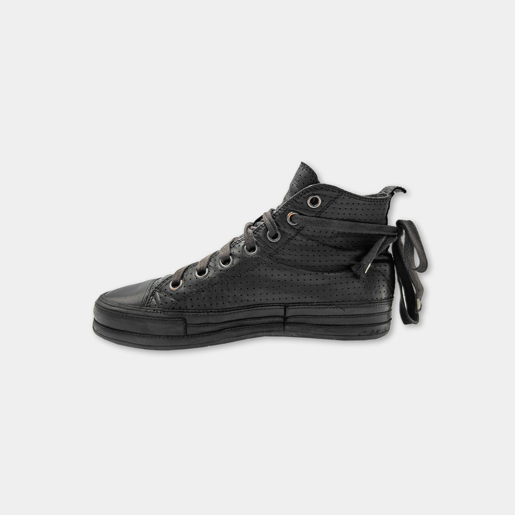A black high-top sneaker with a lace-up design and a black sole.