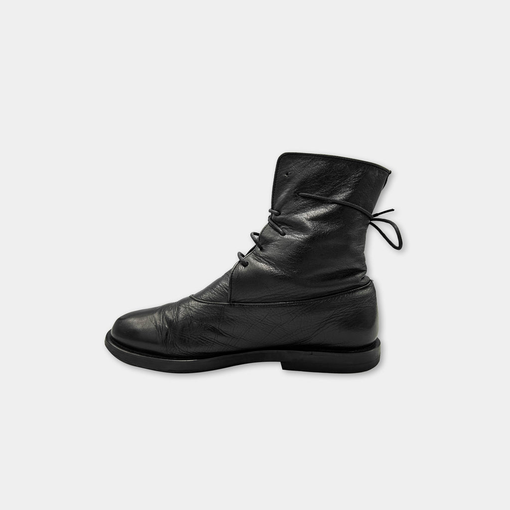 A single black leather boot with a lace-up closure.