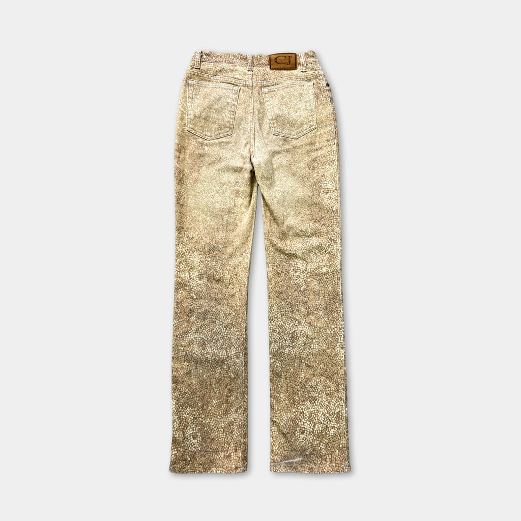 A pair of tan-colored jeans with a distressed pattern.