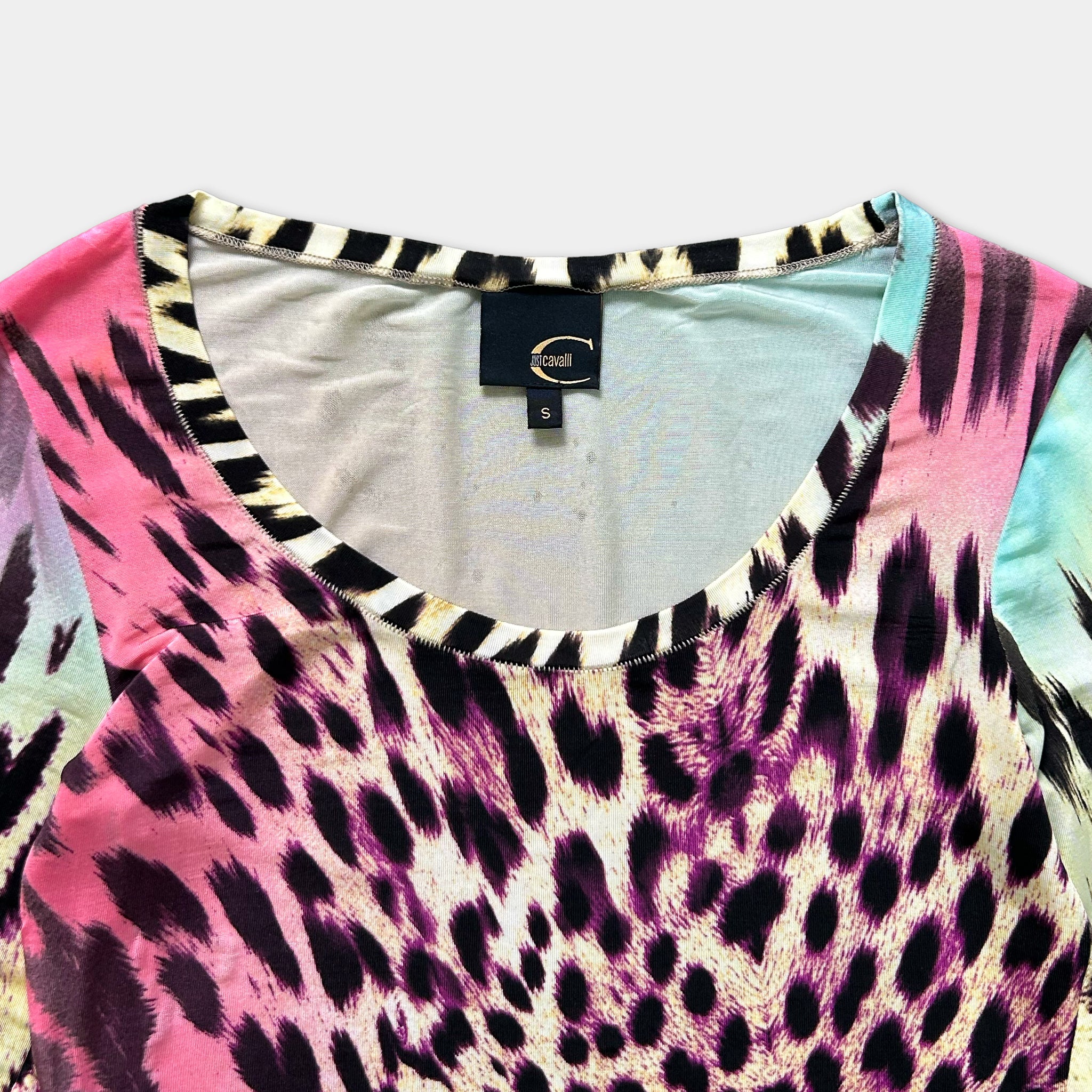 A close-up view of a colorful, patterned shirt with a bold, leopard-like design.