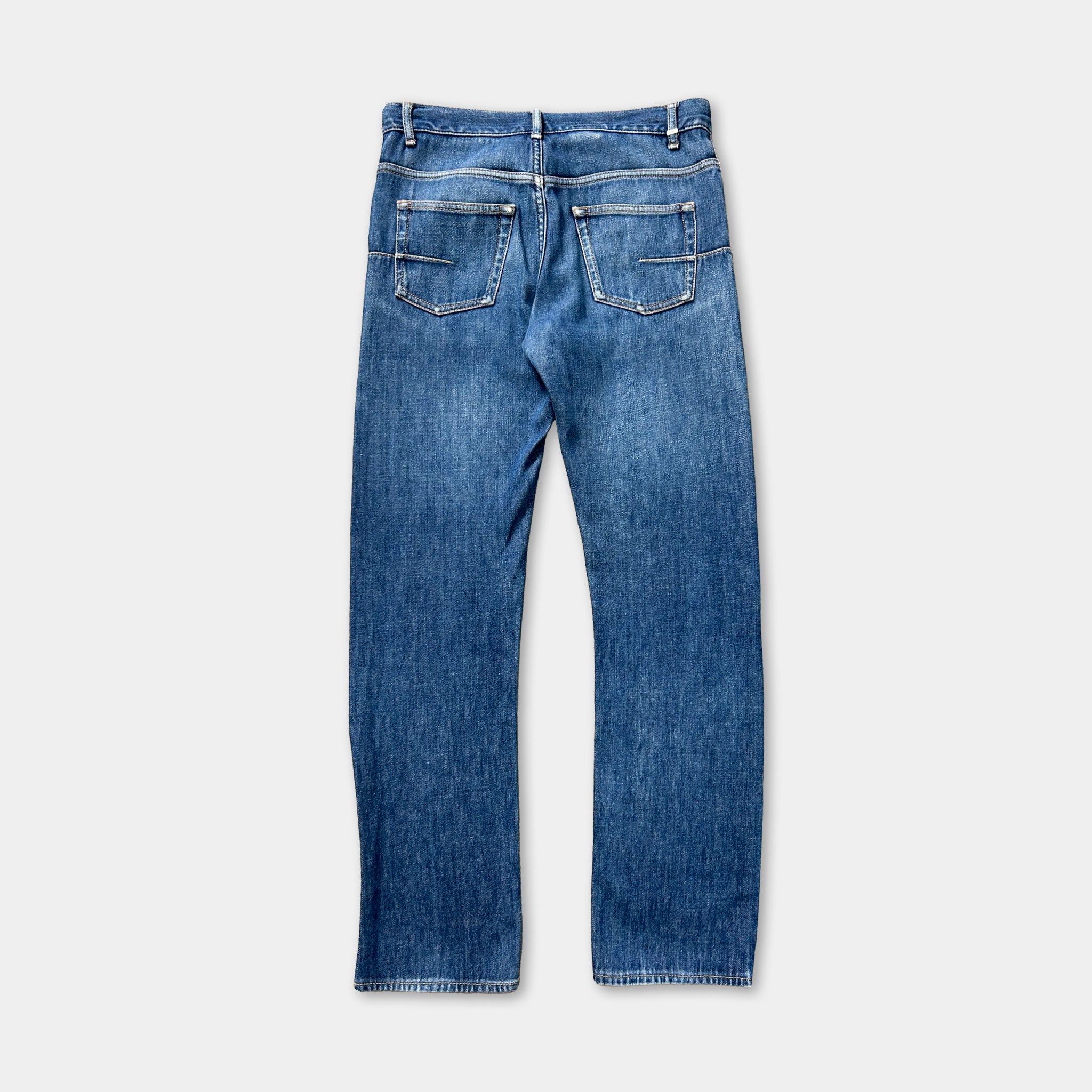 A pair of blue jeans with a classic design, featuring a pocket on the back and a zipper running down the front.