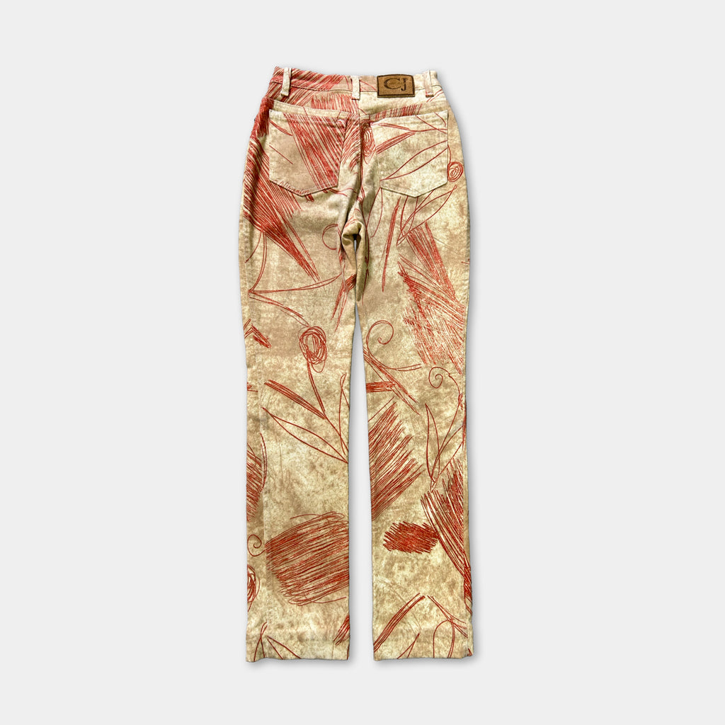 A pair of beige pants with a red and white floral pattern.