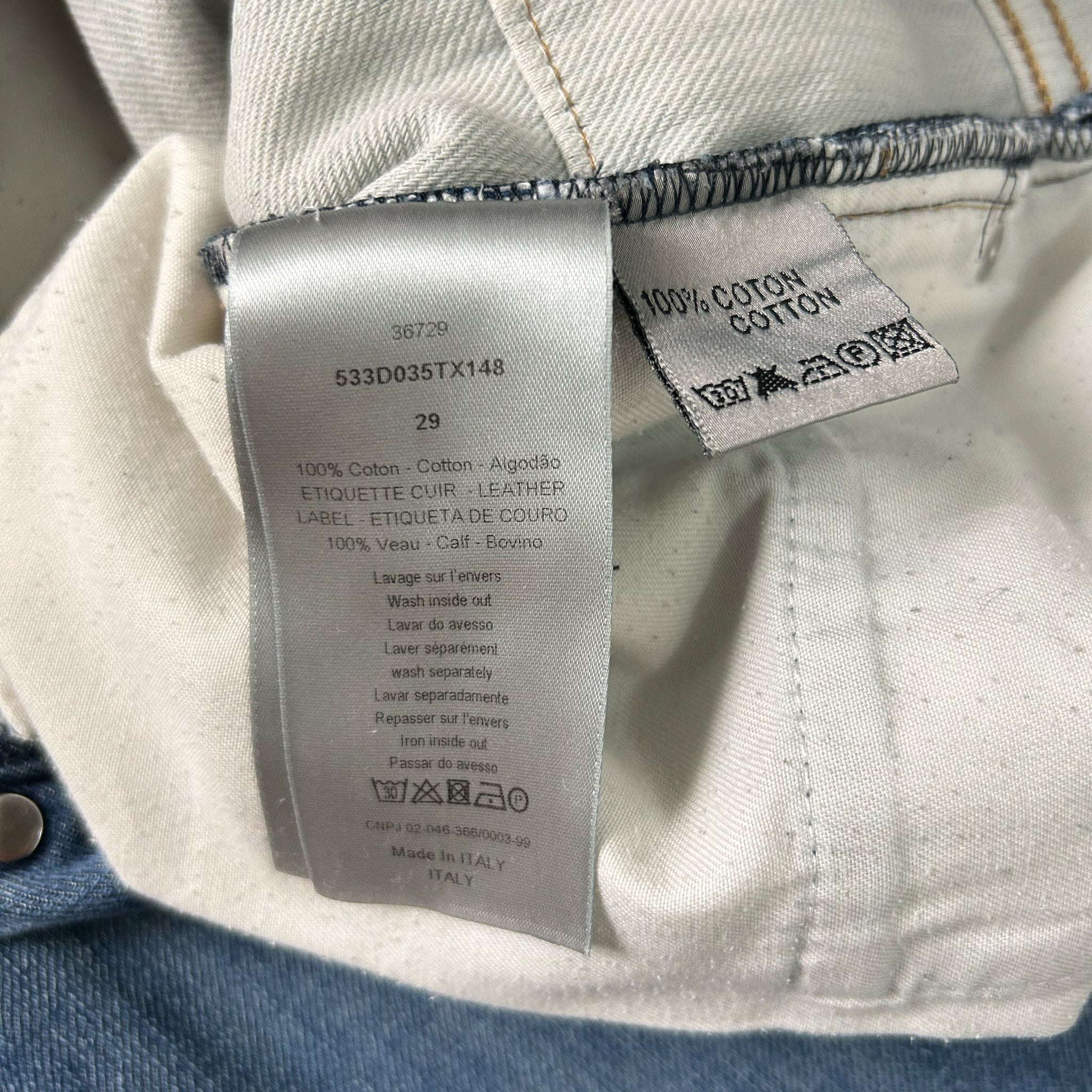 a close-up view of a fabric label on a pair of jeans, with a focus on the details of the label and the jeans themselves.
