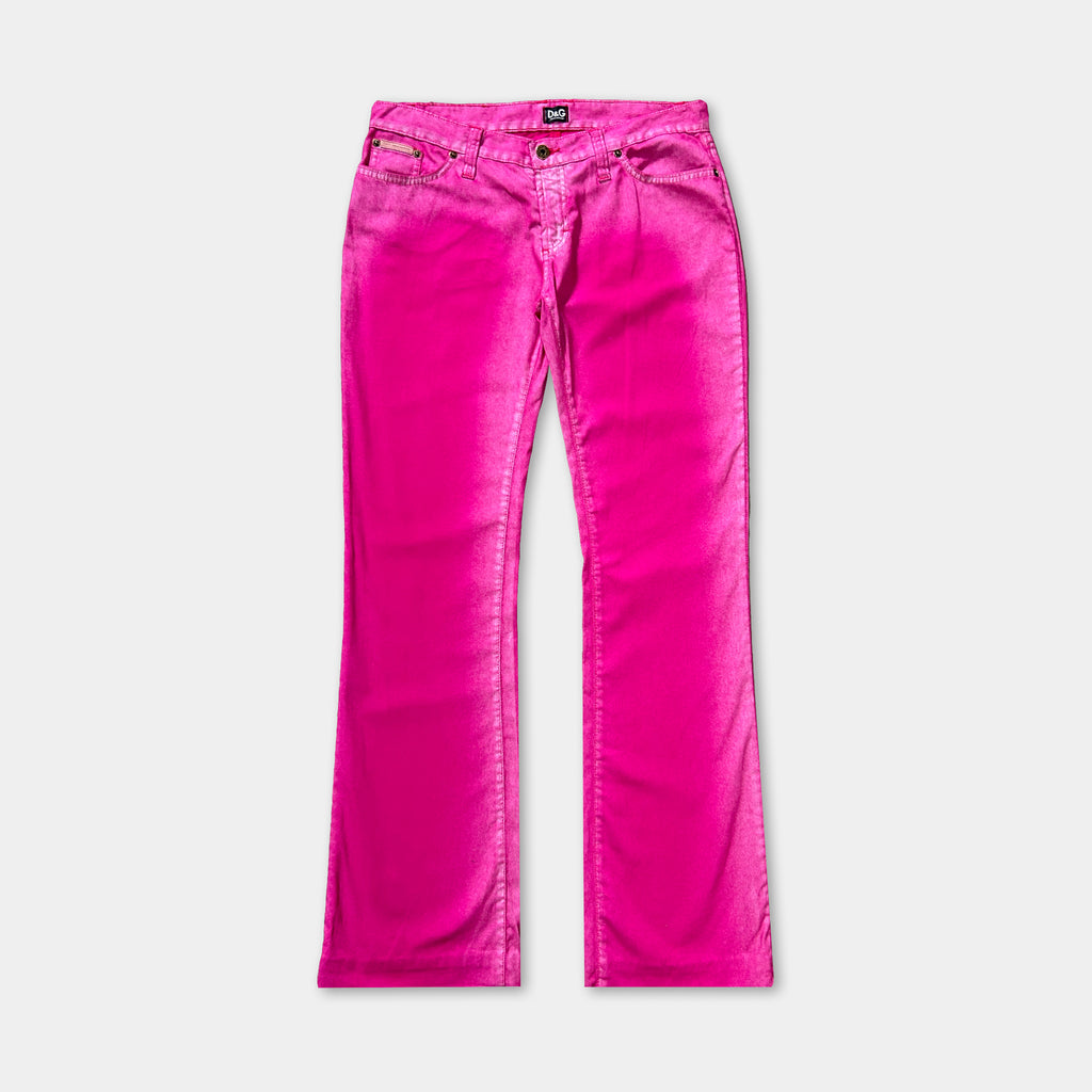 A pair of bright pink jeans against a white background.