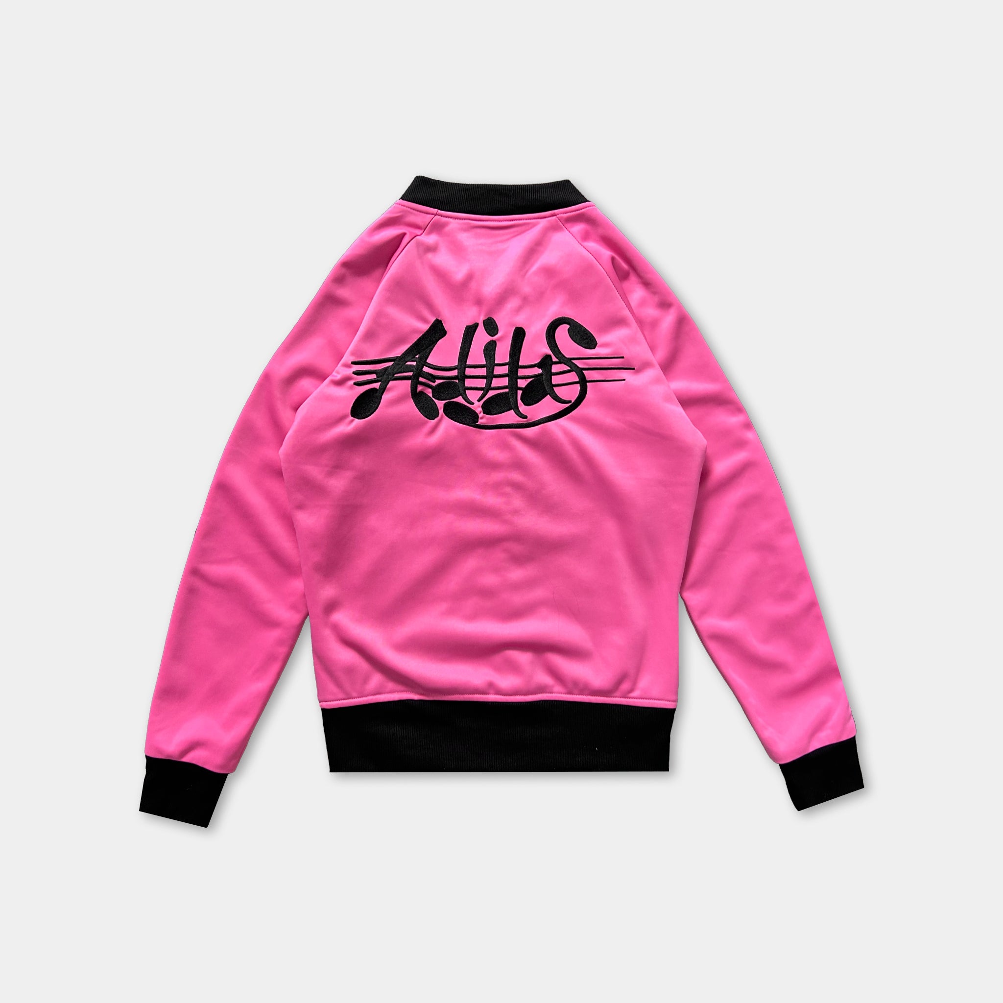 A bright pink sports jacket with black text on the back.