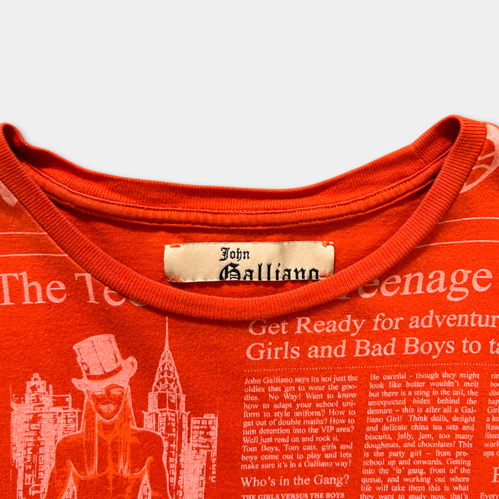 a red t-shirt with a printed label on the collar, featuring a cityscape and a character wearing a top hat.