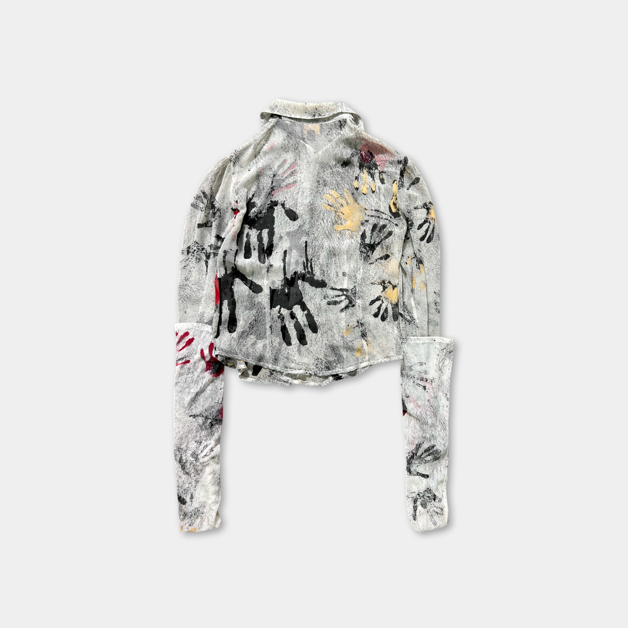 a gray and white patterned jacket with black and red handprints on the front.