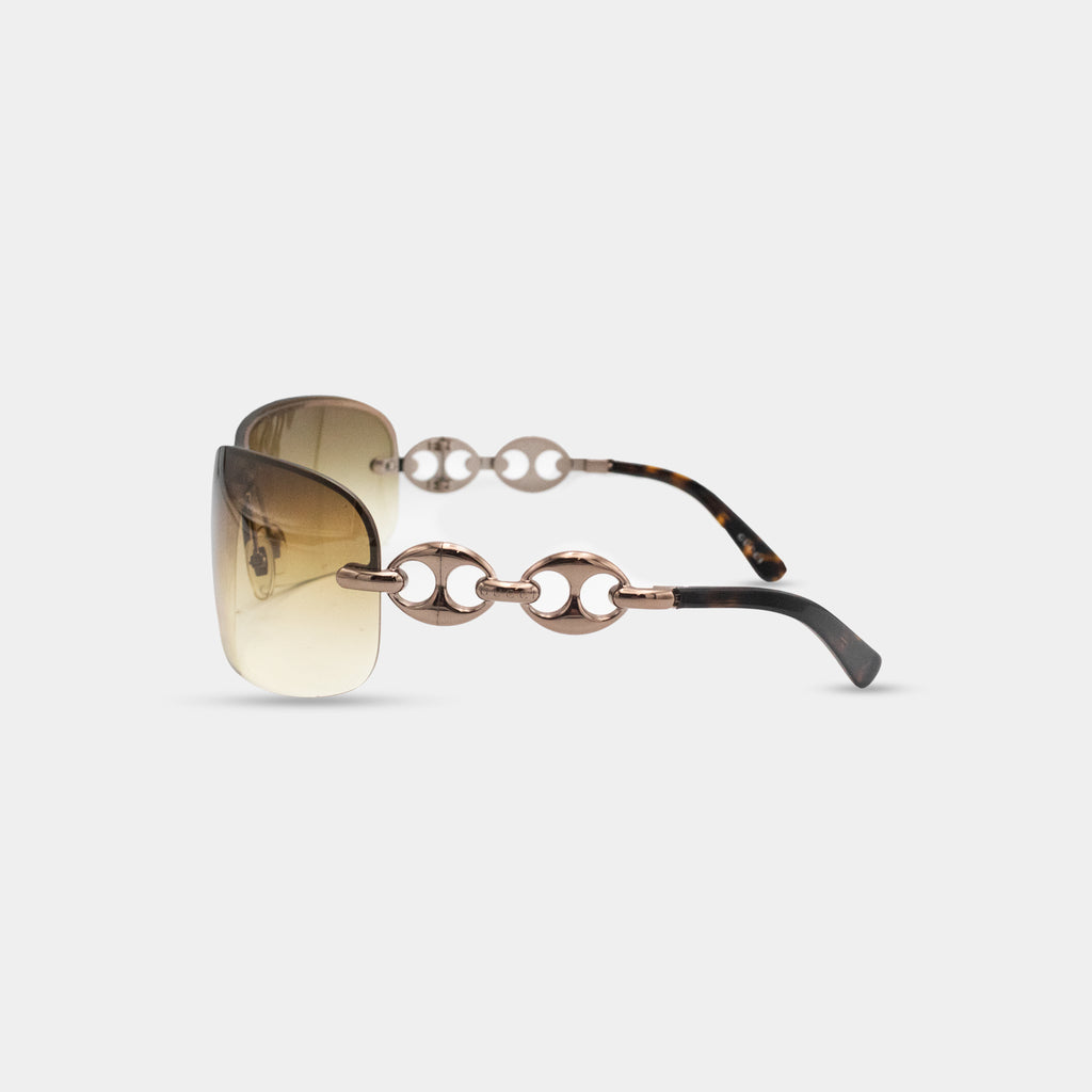 A pair of stylish sunglasses with a gold-tone frame and black temples.