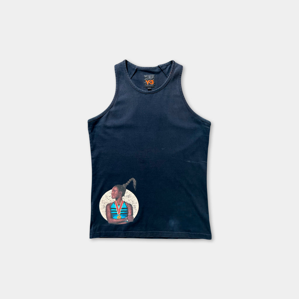 The image is a navy blue tank top with a graphic design on the front, depicting a person with a headdress.