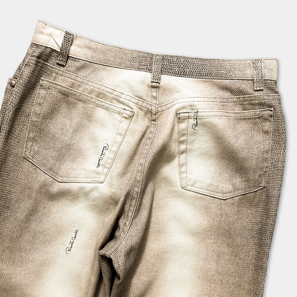a pair of beige-colored jeans with a distinctive pattern, featuring a zipper detail and a small logo on the back pocket.