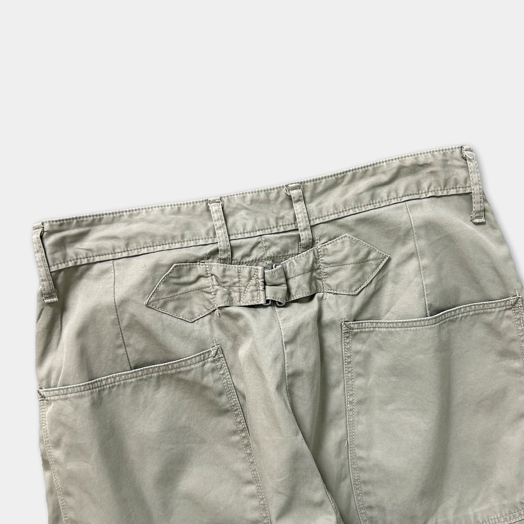 a pair of khaki cargo shorts with a belt and pockets.