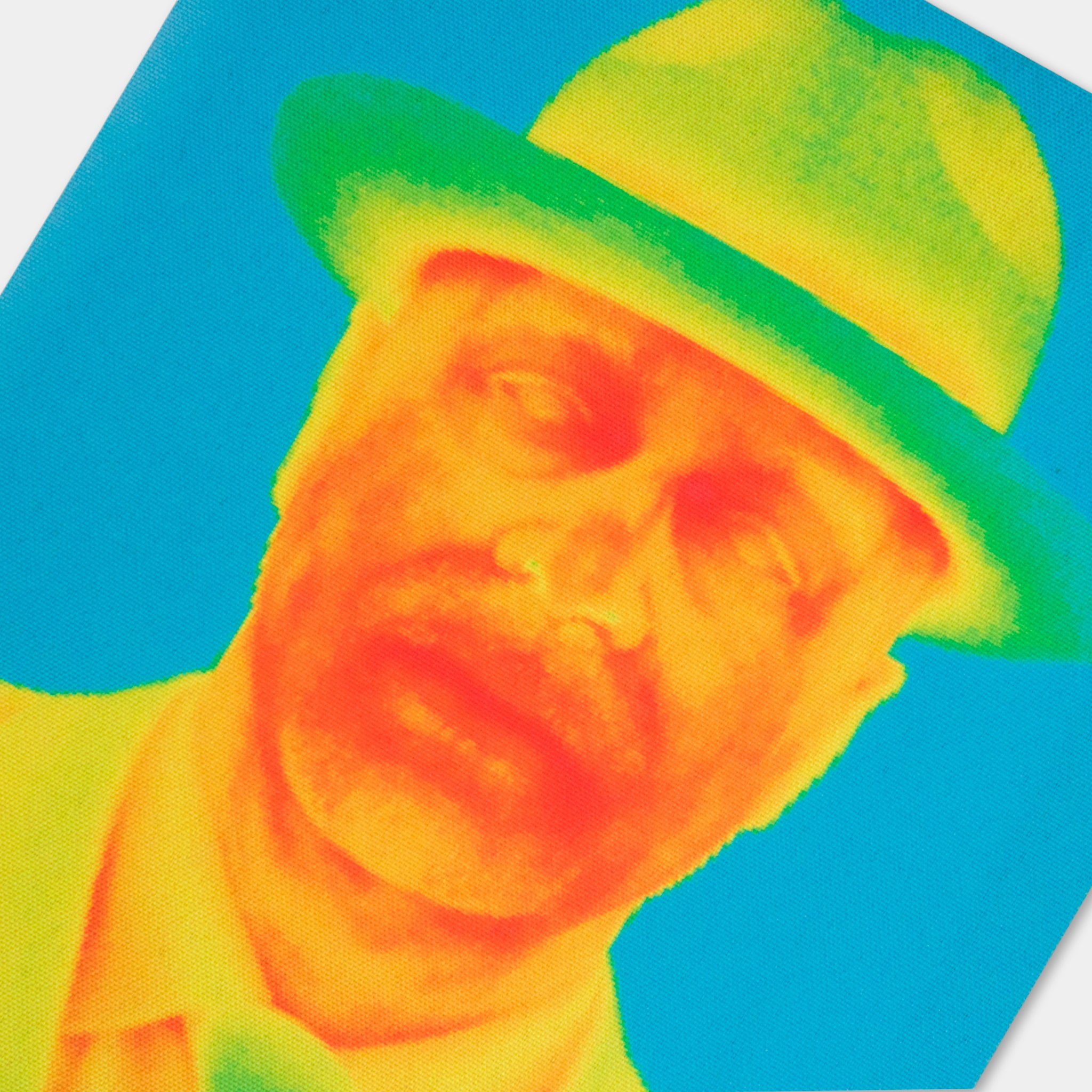A close-up of a man wearing a green hat against a blue background.