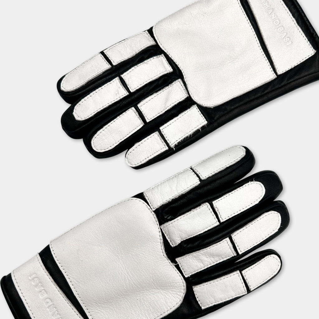 A pair of white and black gloves with a distinctive design.