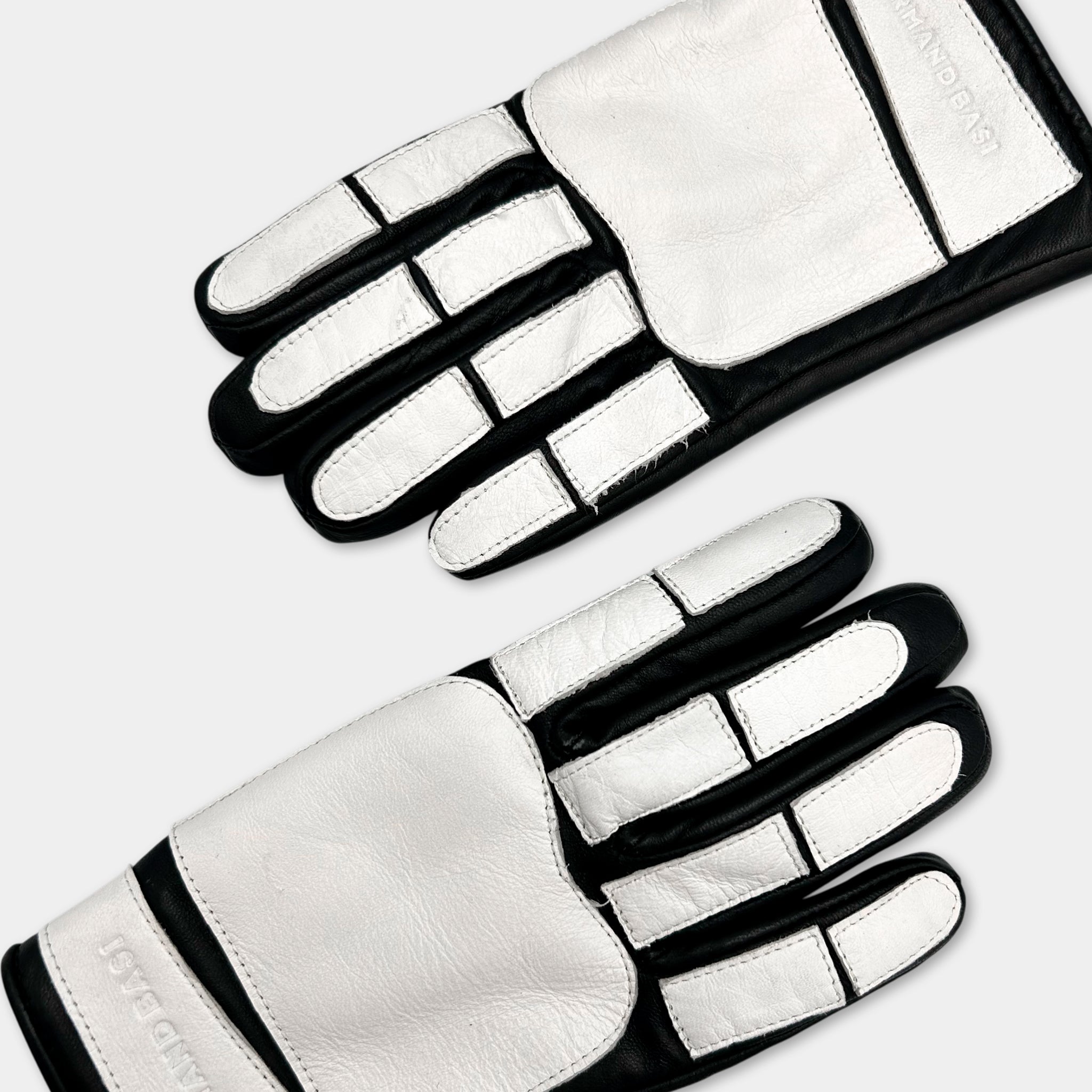 A pair of white and black gloves with a distinctive design.