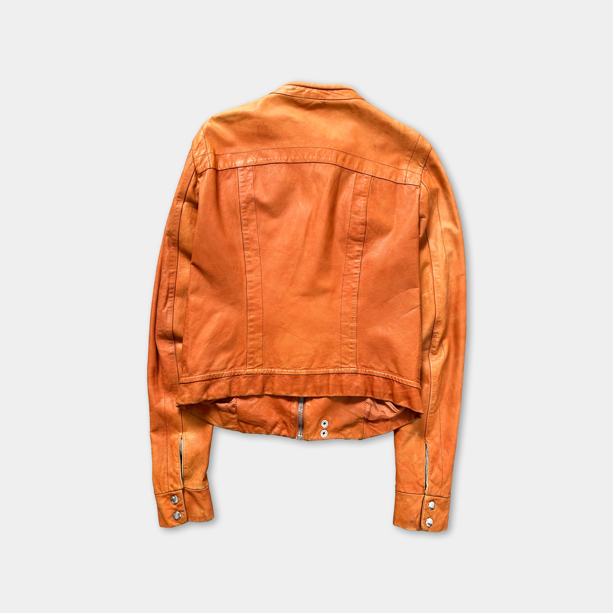 An orange leather jacket is displayed against a white background.