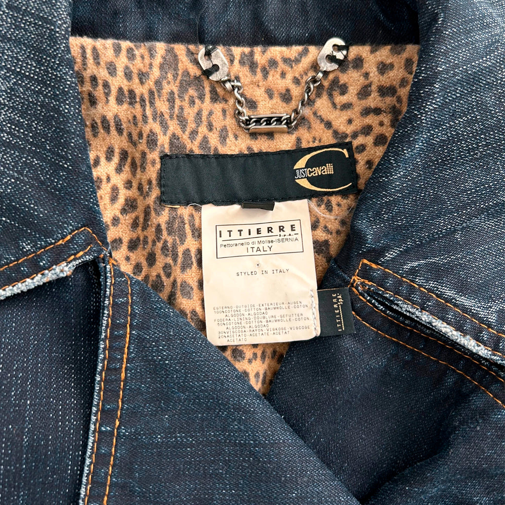a close-up view of a denim jacket with a leopard print pattern inside the pocket. The jacket has a tag attached to it, which appears to be a label or tag from the brand "Ittierre".