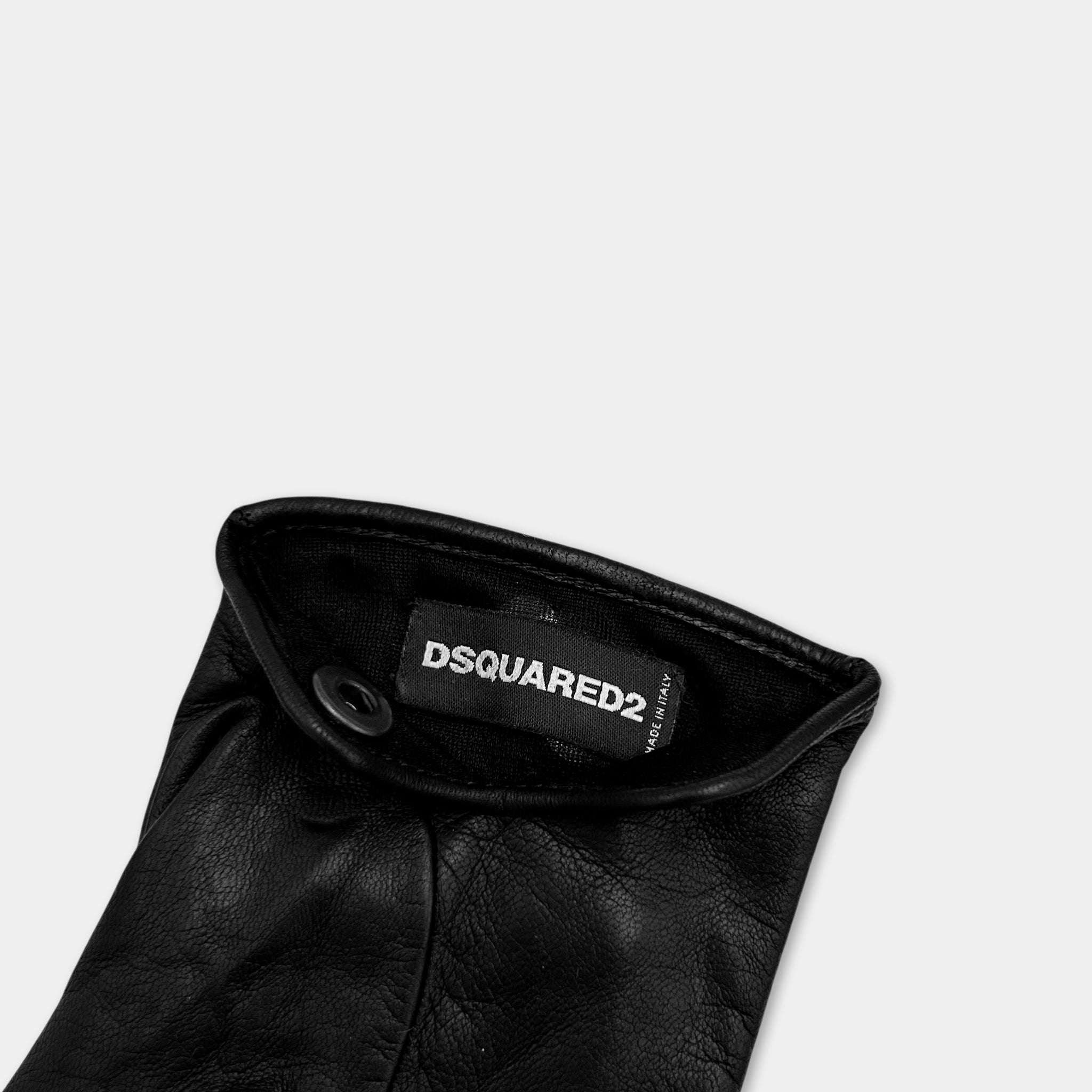 A black leather glove with a label on it.