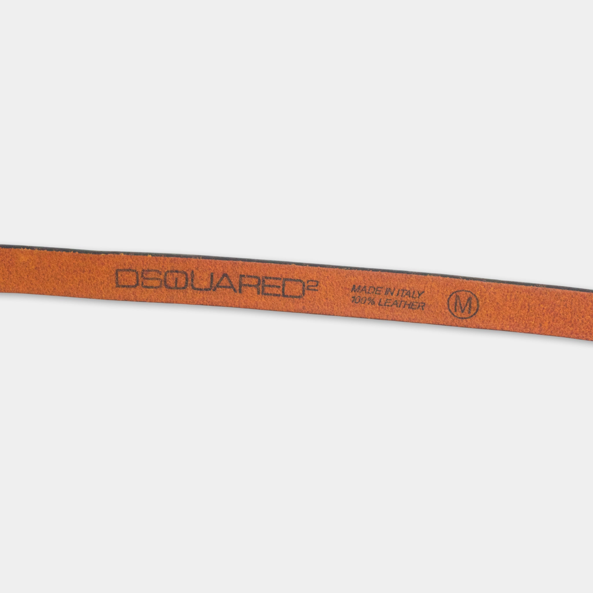 A close-up view of a leather belt with the brand name "DQUARED" printed on it.