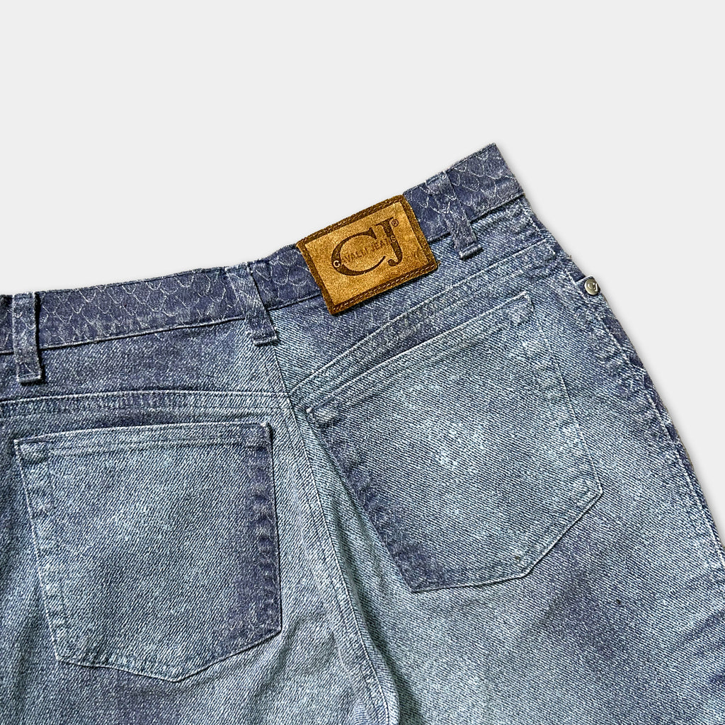 A pair of blue jeans with a brown leather patch on the back pocket.