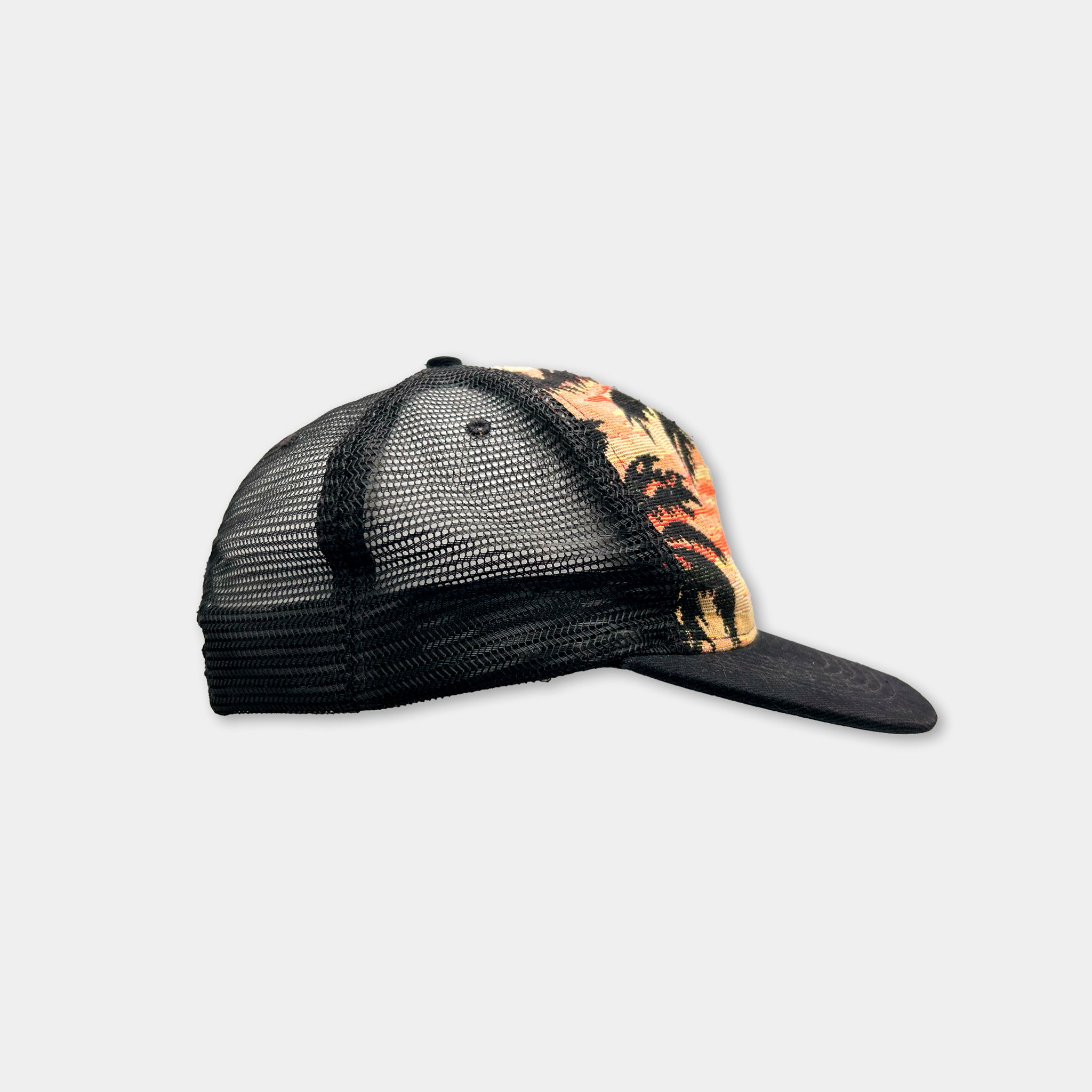 A black mesh baseball cap with a colorful, tropical-themed design on the side.
