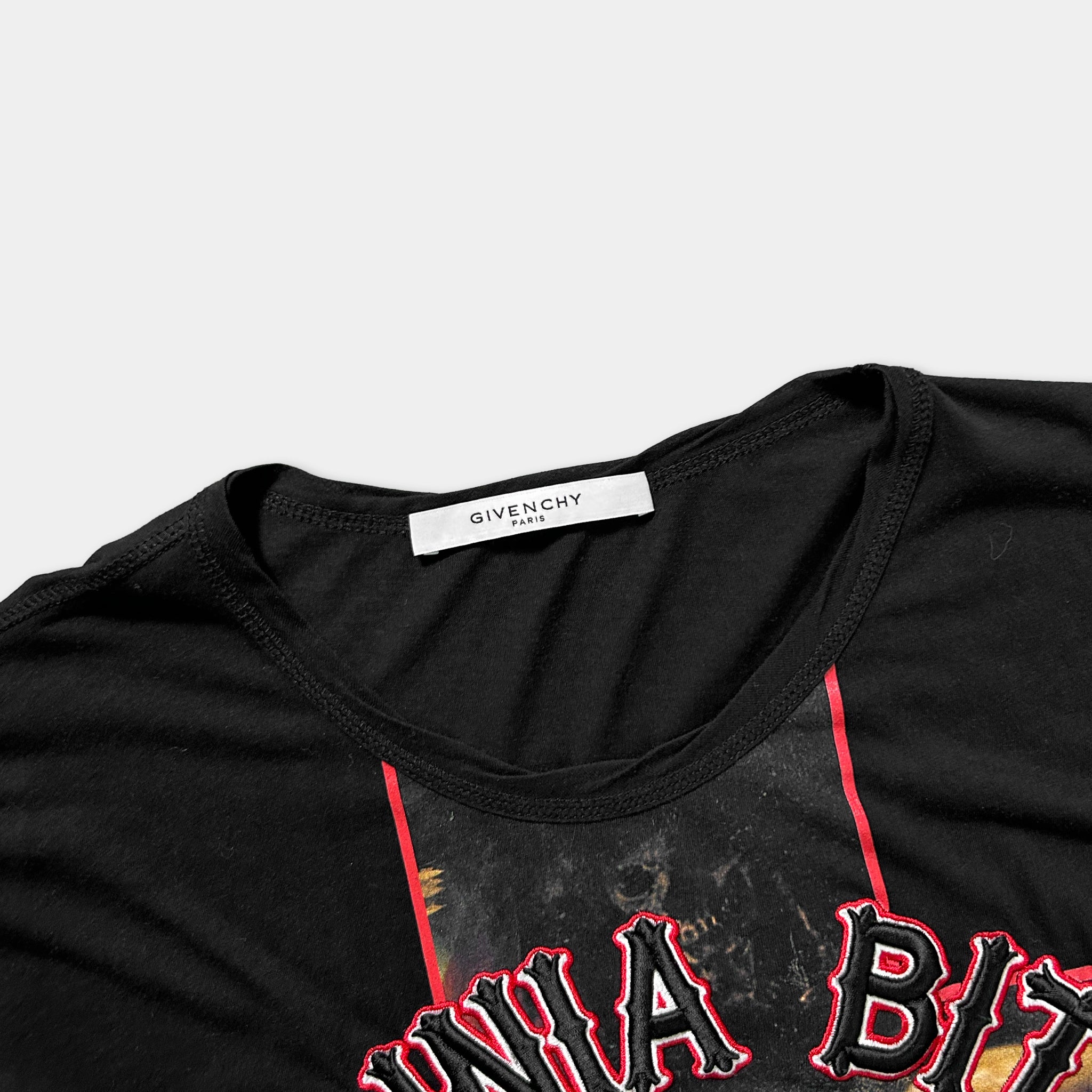 a black t-shirt with a red and black graphic design on the front.