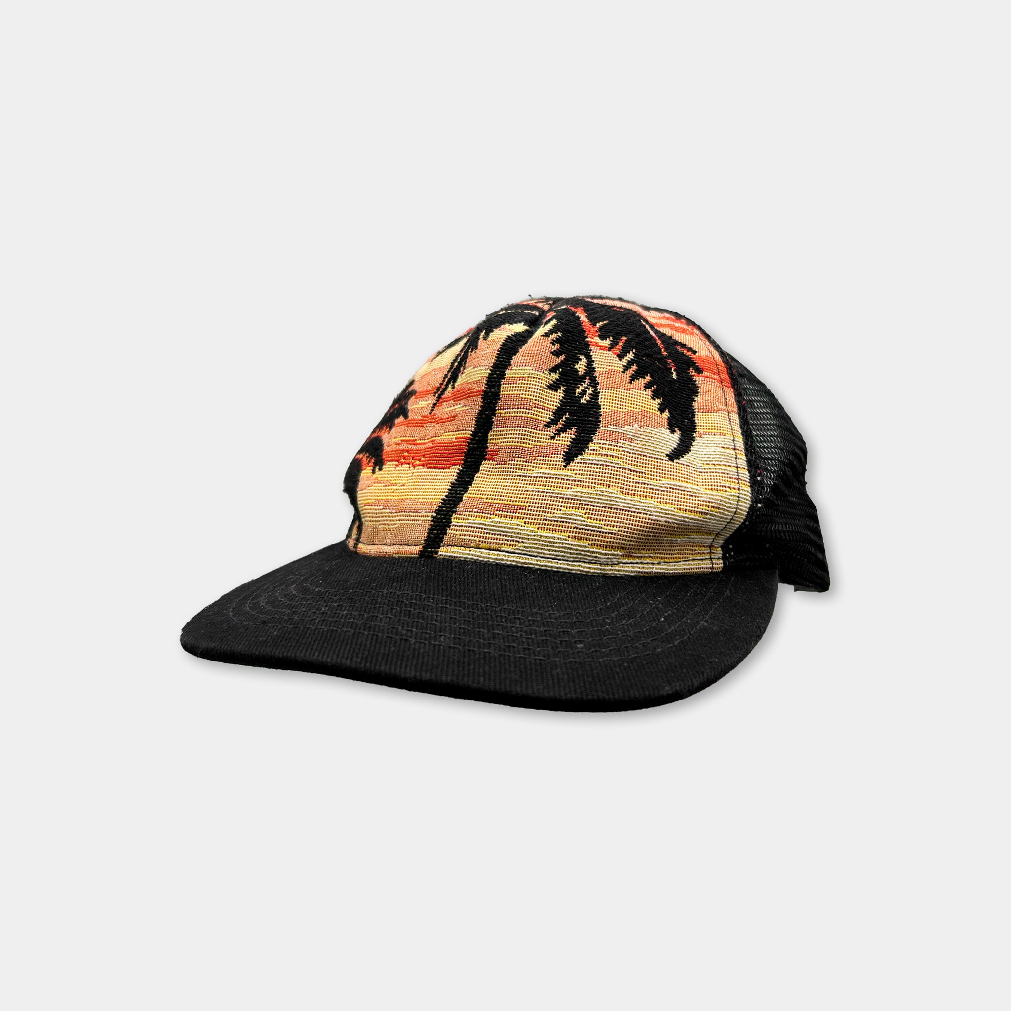 A black baseball cap with a palm tree design printed on it.
