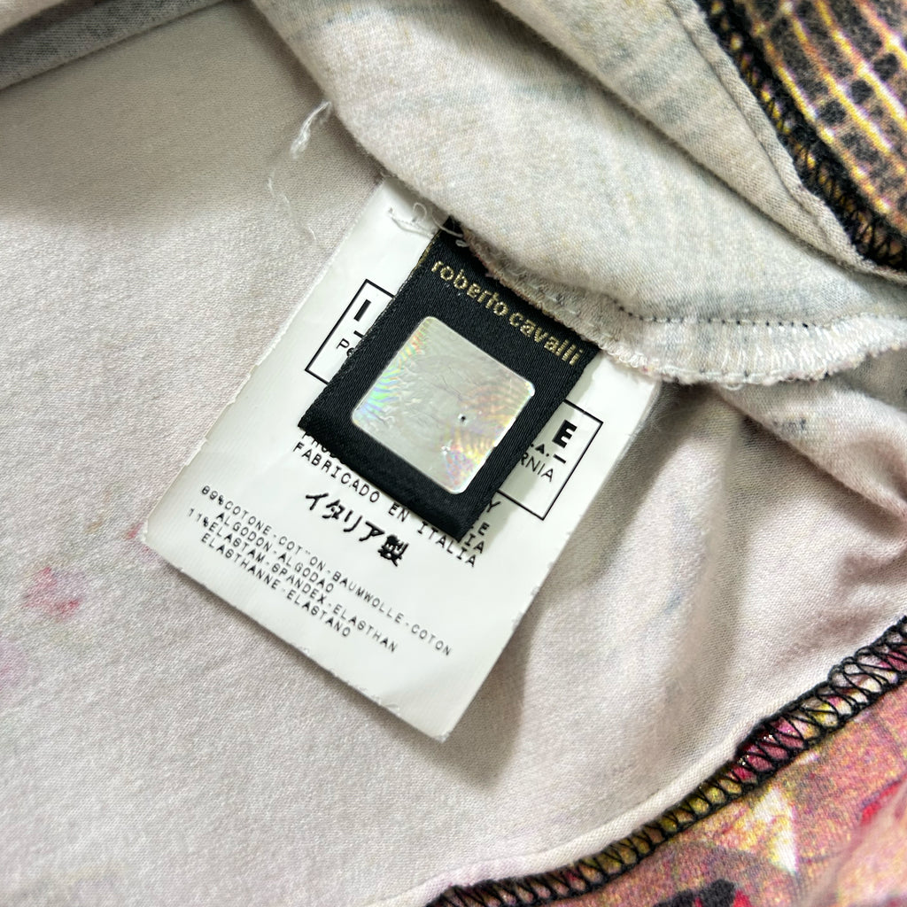 a close-up view of a fabric label with text and a small, reflective object attached to it.