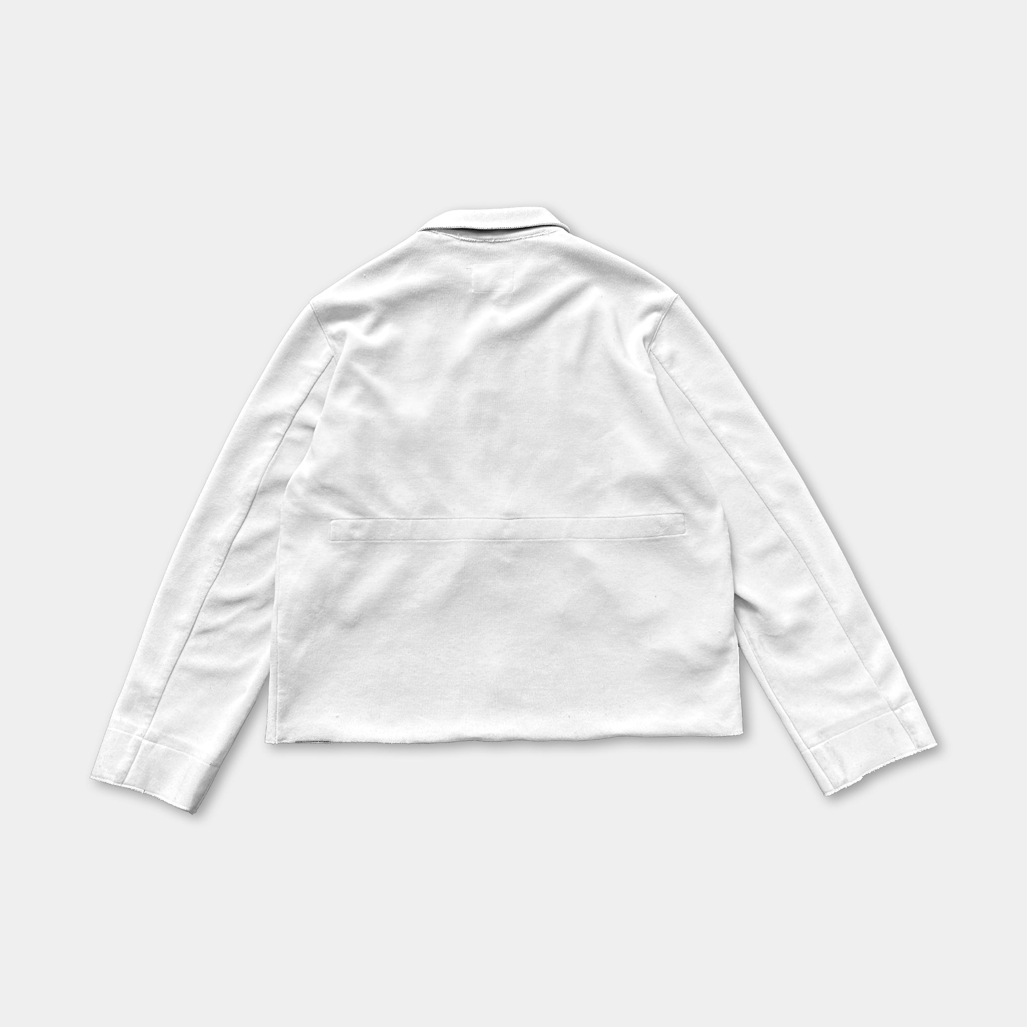 A white long-sleeved shirt is shown against a plain background.