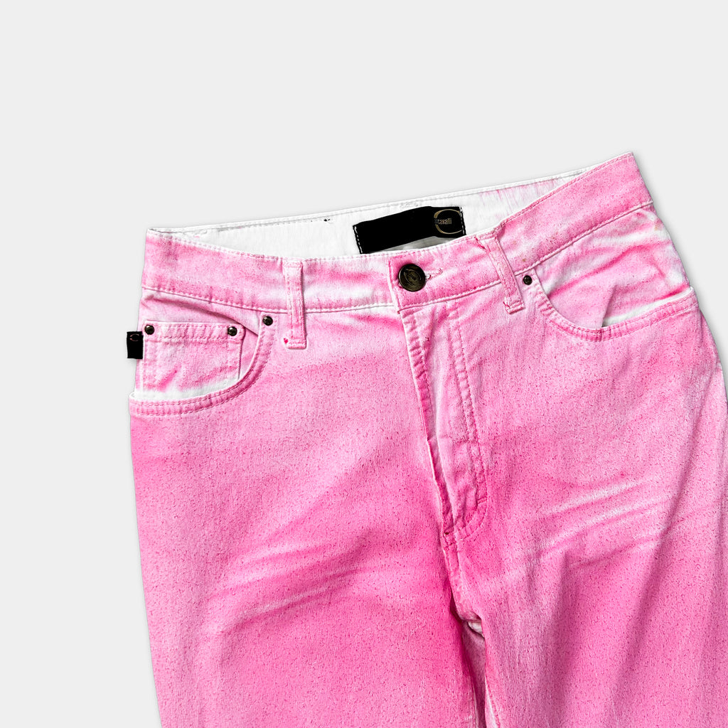 A pair of pink jeans with a black belt and zipper.