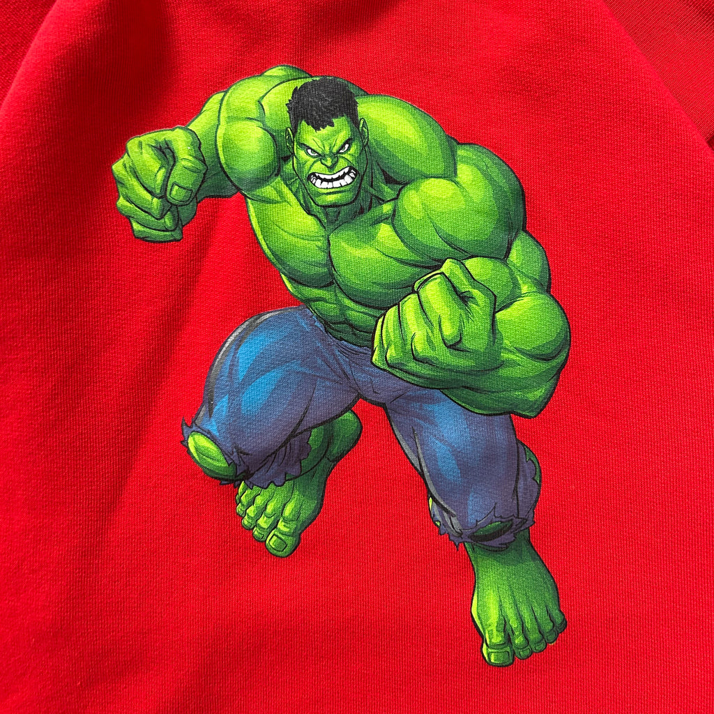 A muscular, green-skinned character with a determined expression is depicted in a dynamic fighting stance against a red background.
