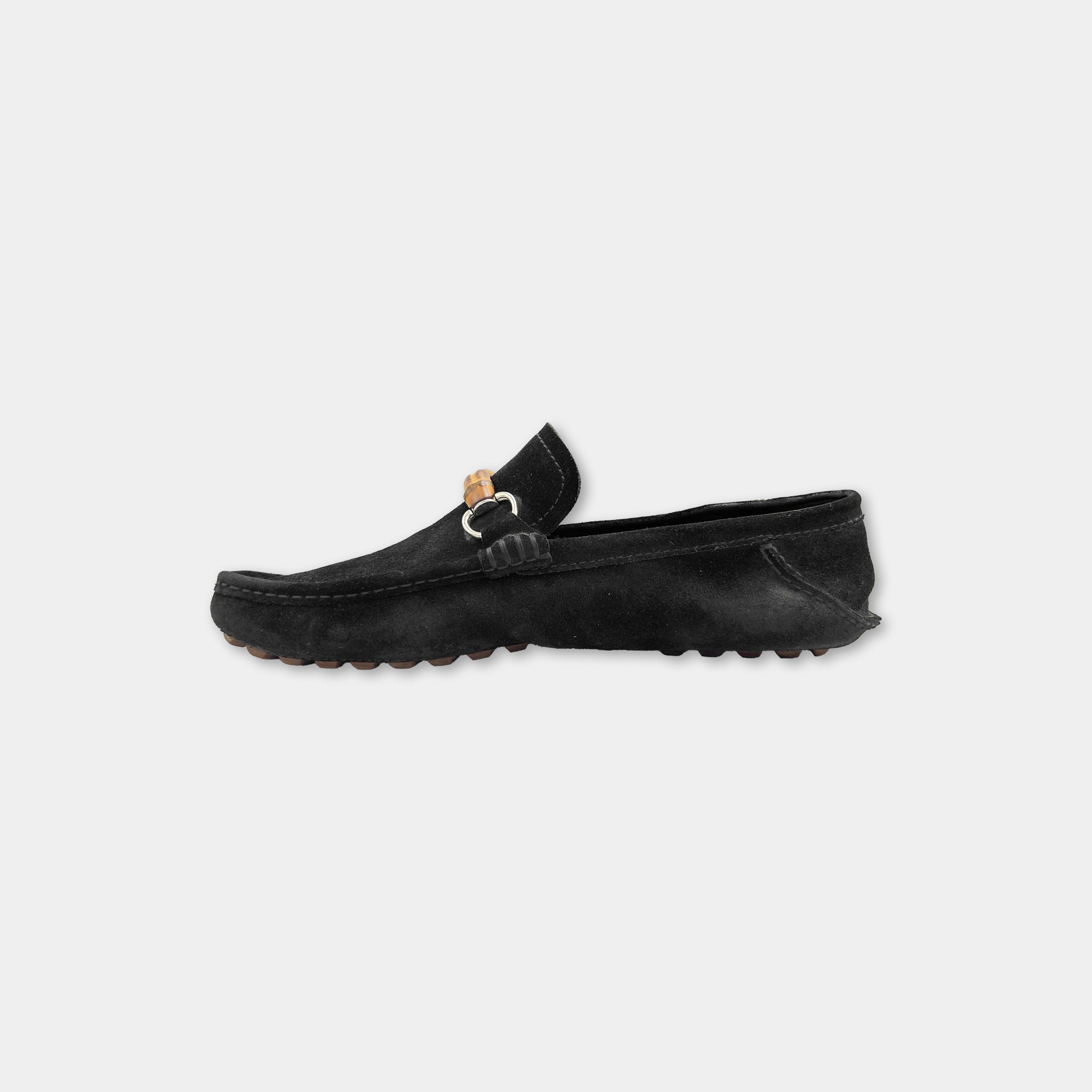 A black leather loafers with a distinctive buckle detail.