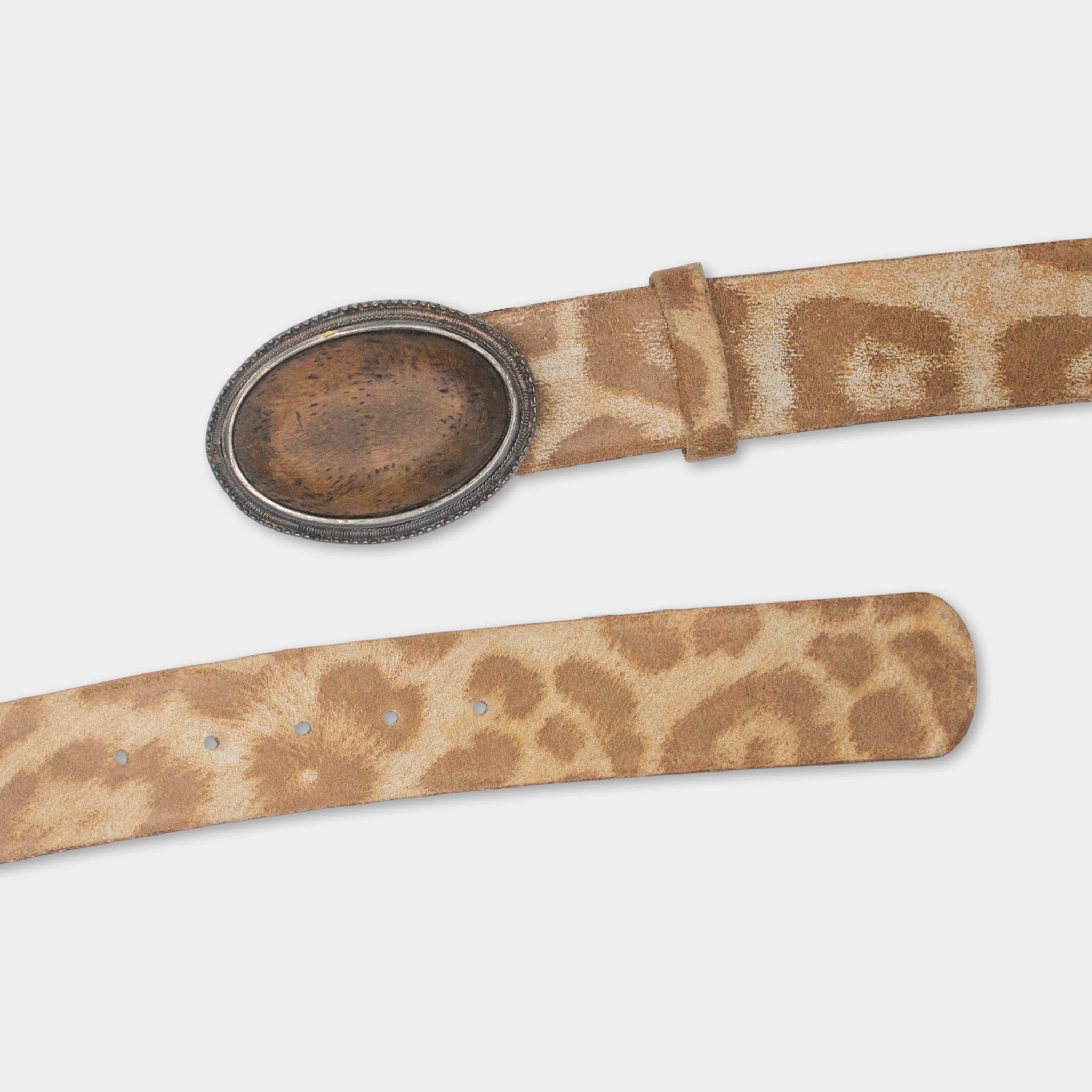 A tan leather belt with a round metal buckle featuring a leopard print pattern.