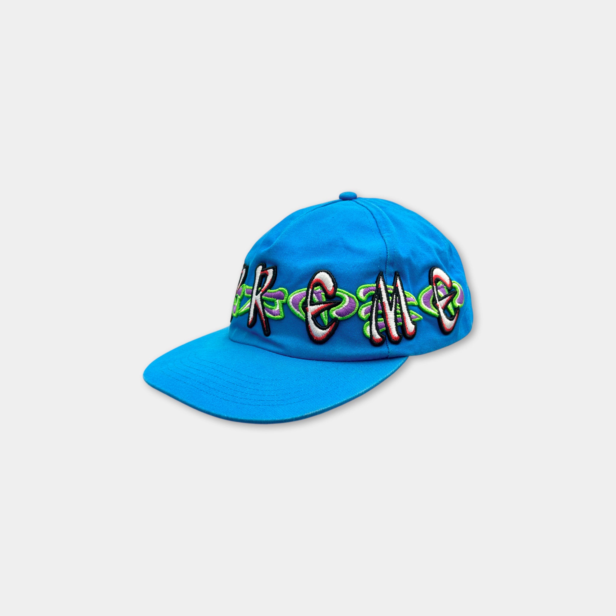 A blue baseball cap with colorful embroidered text on it.