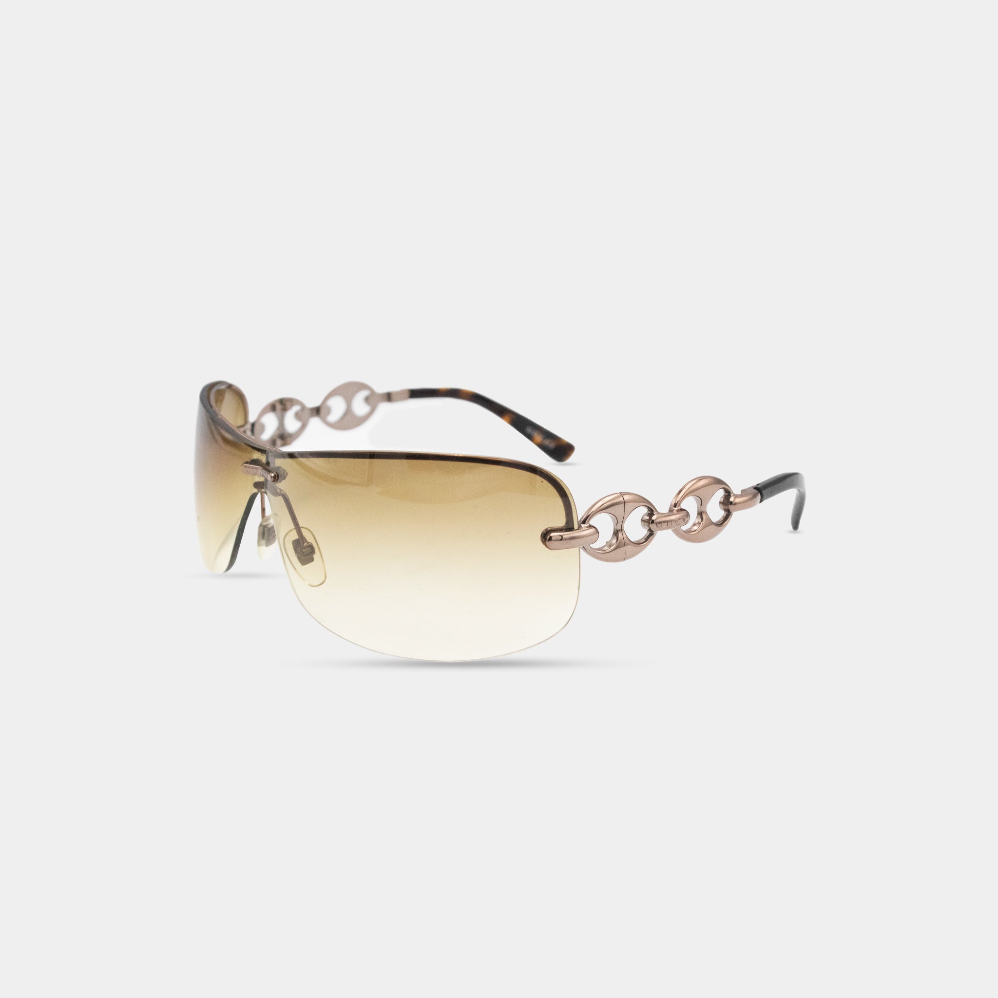 A pair of stylish sunglasses with a gold-tone frame and chain-link accents.