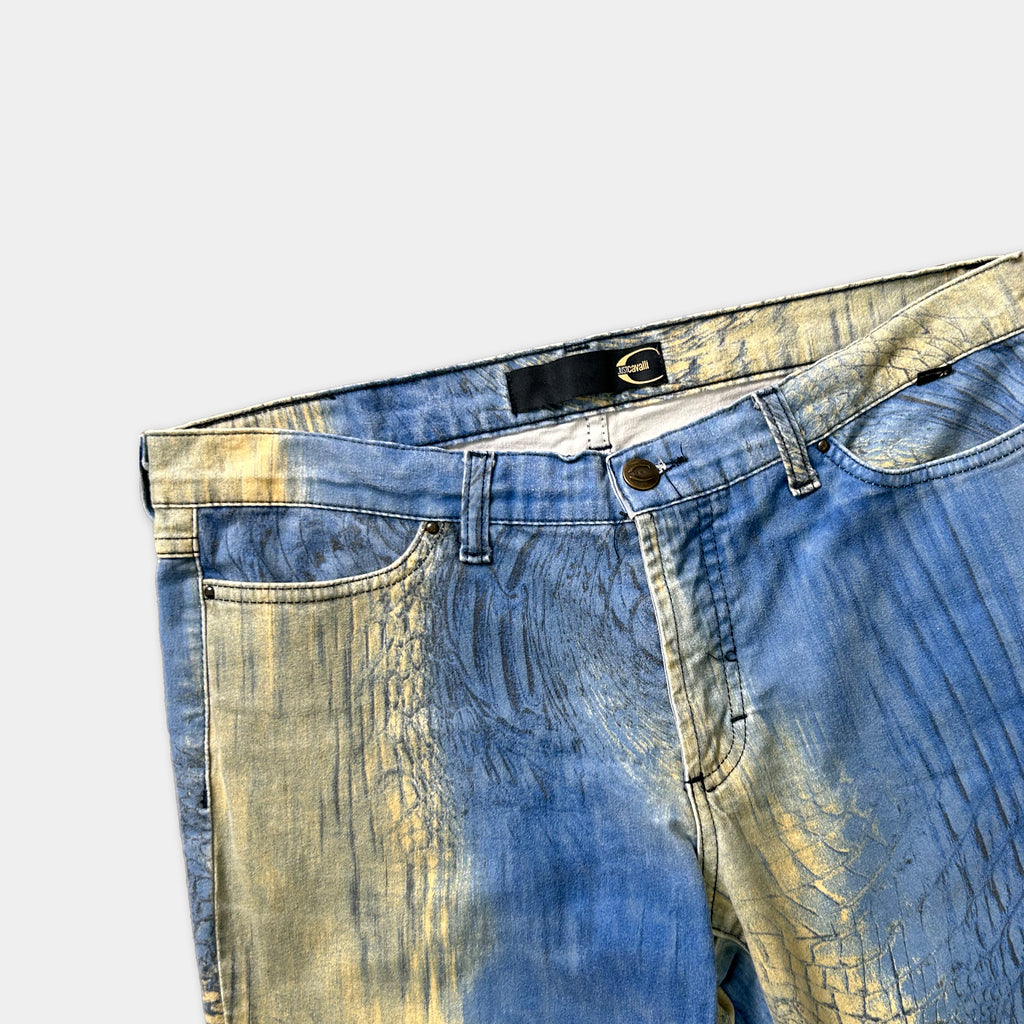 A pair of blue jeans with a unique, textured pattern in shades of blue and yellow.