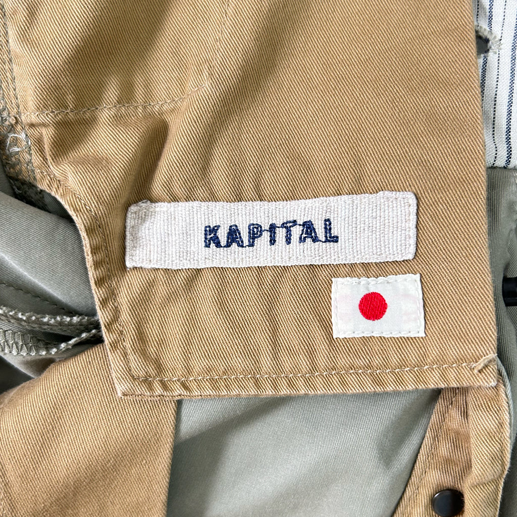 a close-up view of a beige fabric with a label and a small flag attached to it.