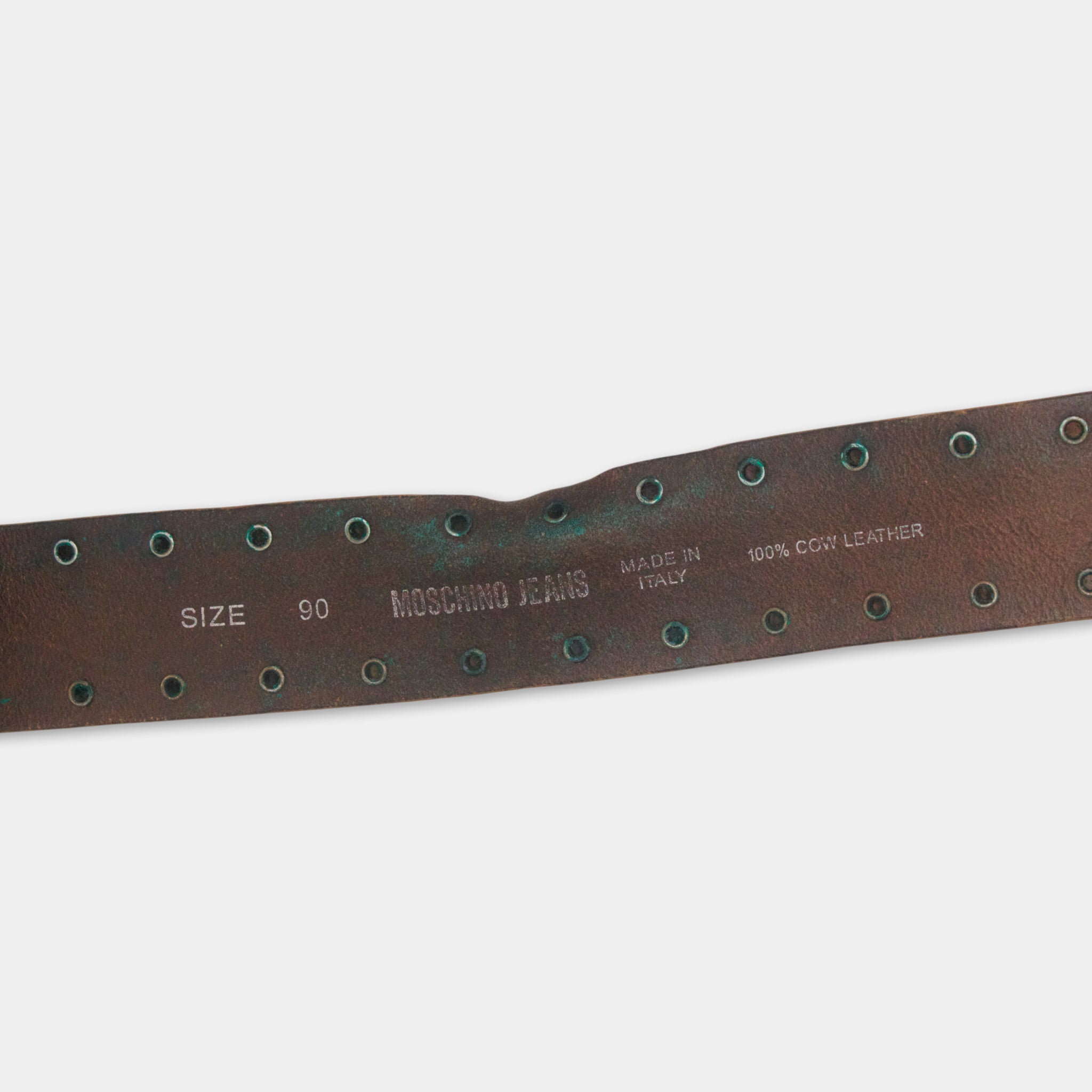 A brown leather belt with metal studs and text indicating the brand and material.