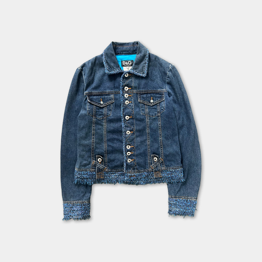 A denim jacket with frayed edges and buttons, displayed against a white background.