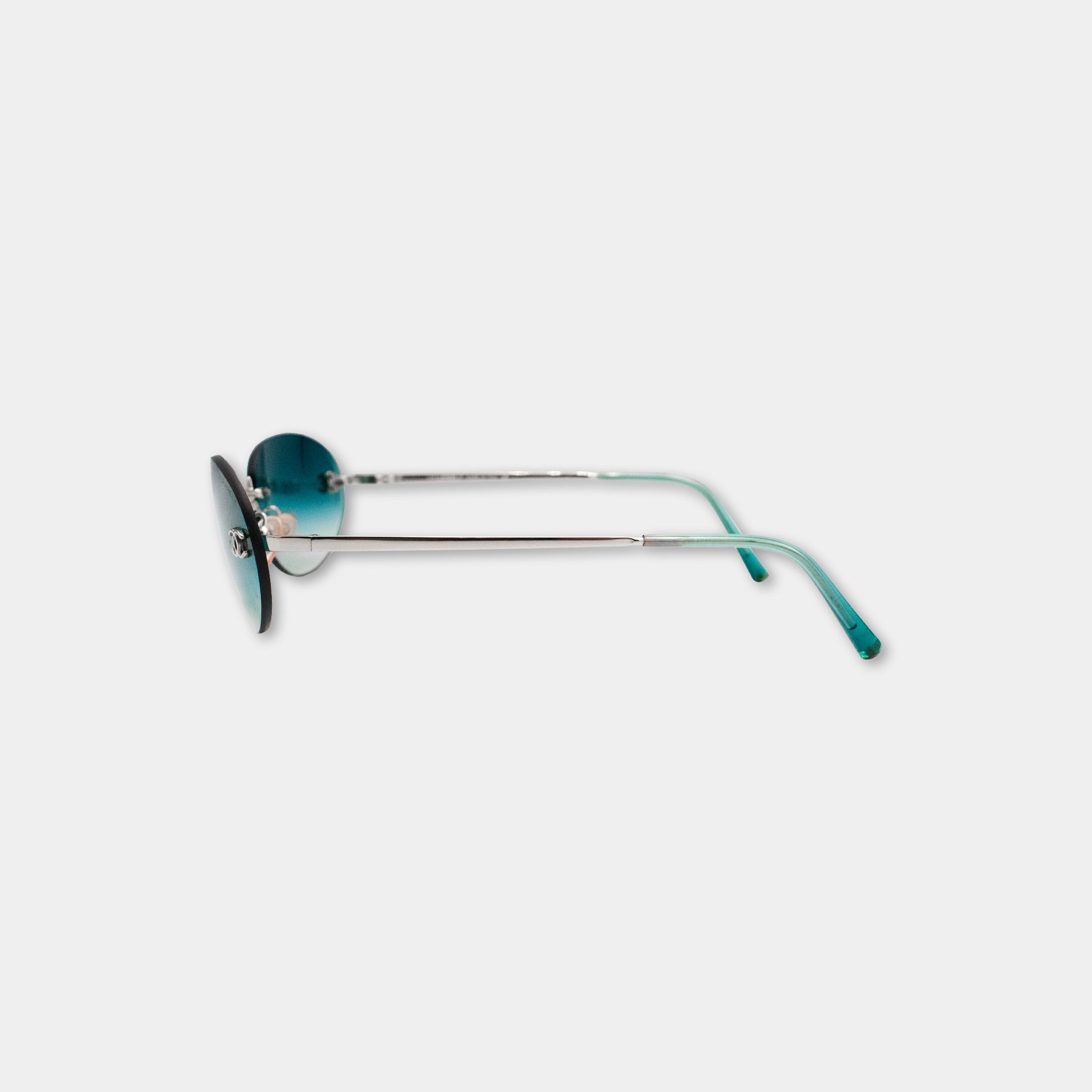 A pair of blue-tinted sunglasses with a silver frame is shown against a plain white background.