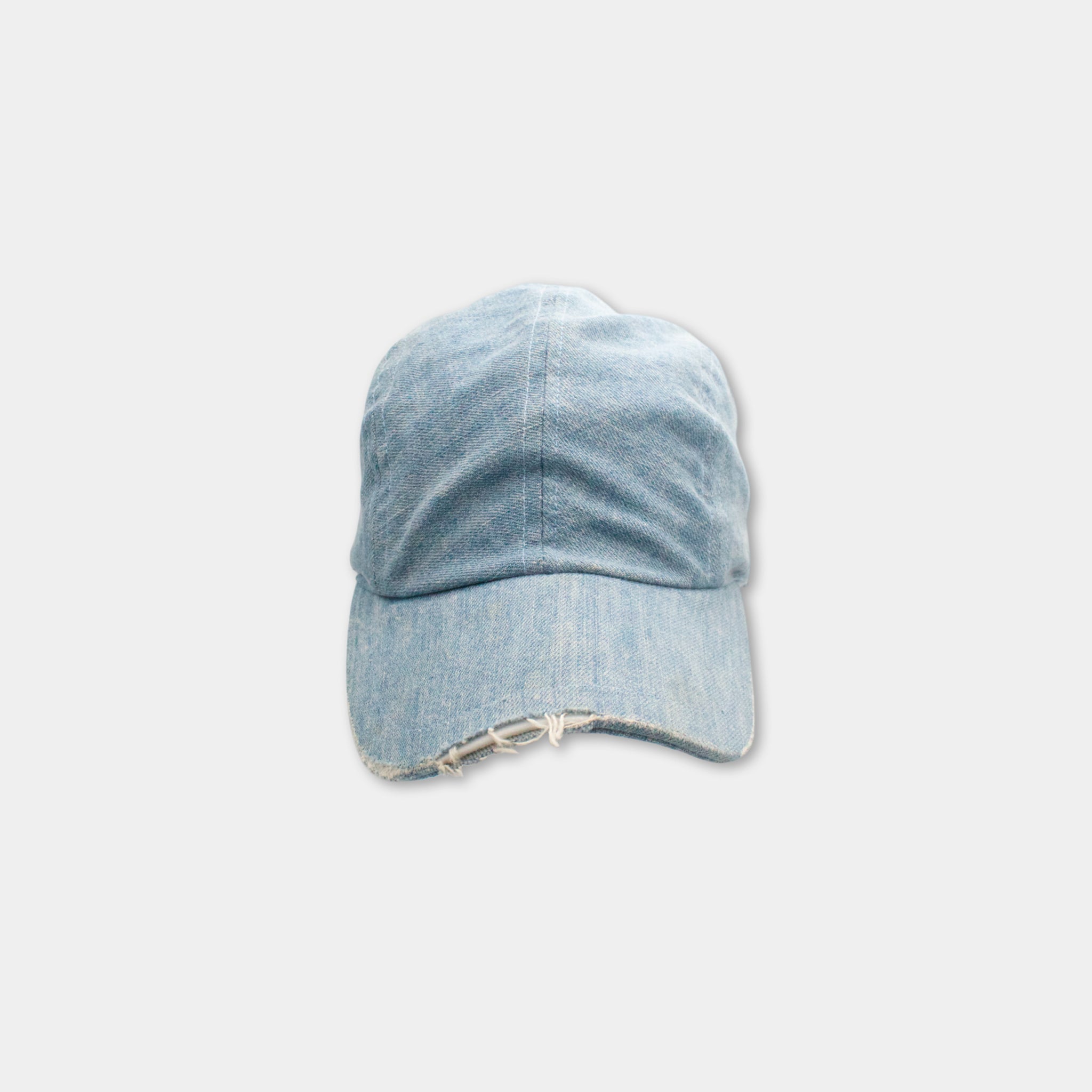 A blue denim baseball cap with frayed edges is shown against a plain white background.