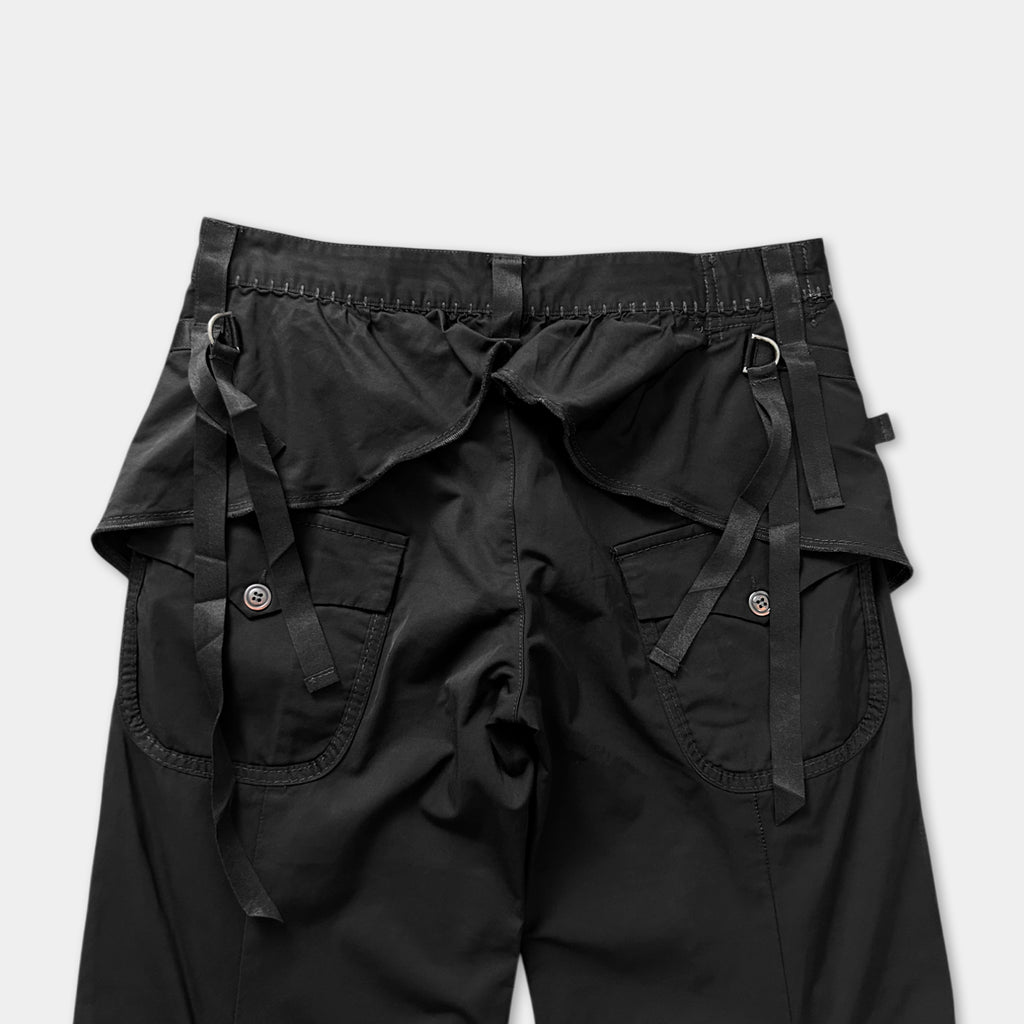 a pair of black cargo pants with multiple pockets and straps.