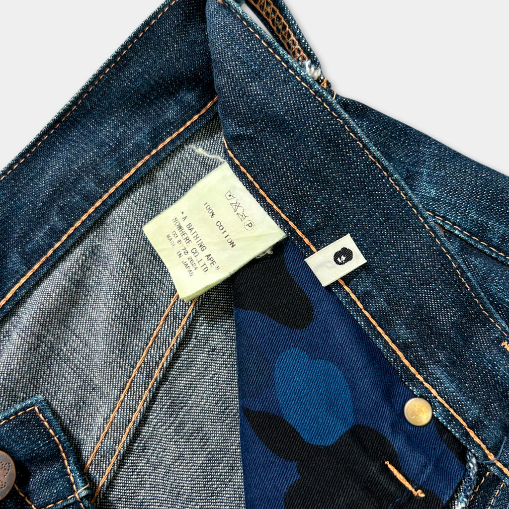 a close-up view of a pair of blue jeans with a label attached to the pocket.