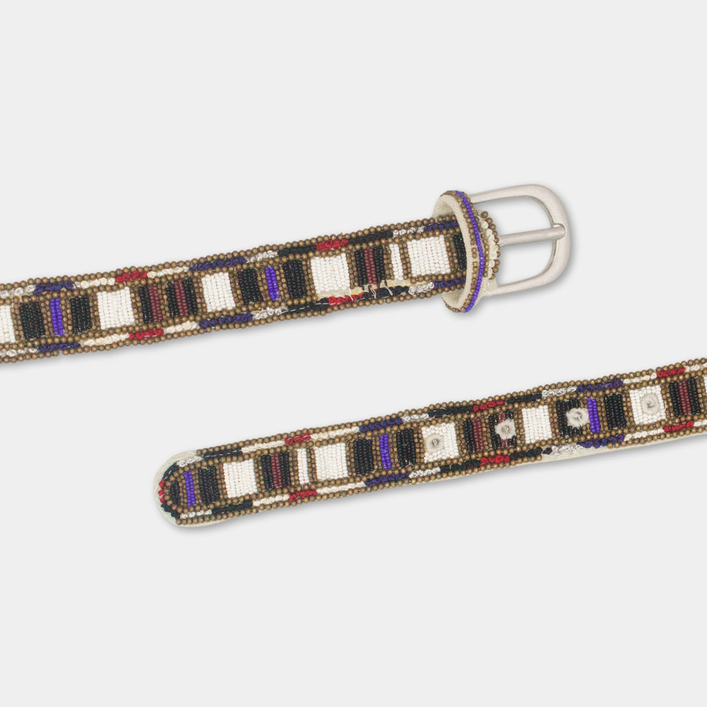 a decorative beaded belt with a pattern of alternating black, white, and purple beads. The belt has a silver buckle and is displayed against a plain white background.